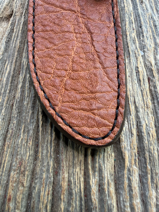 New Randall Model 23 Sheath in Exotic thick and textured Rust colored Elephant hide on brown leather from Treeman with a black Canteen snap. Hand tooled belt loop. Killer sheath.