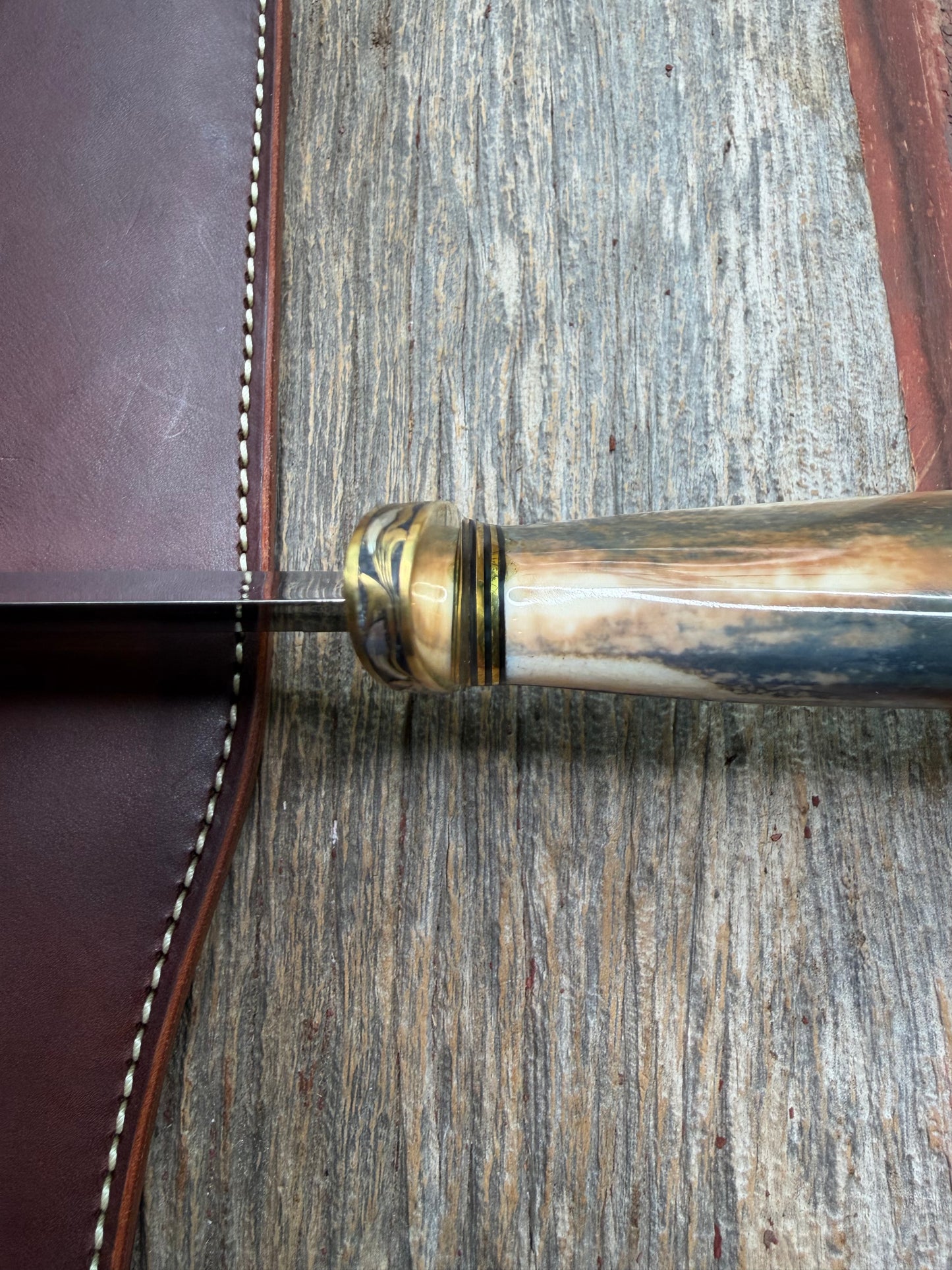 Randall Model 12-11 Smithsonian “Smitty” in a Huge piece of Green, Brown and Blue Fossil Walrus Ivory. Brass Hilt and Brass Butt plate fully engraved in Silver from Jere Davidson.  Stunning piece.