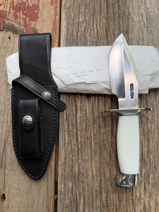 New in Paper Randall Model 19-5 Bushmaster with a White Ivorite handle. Stainless steel blade, Nickel silver hilt. Upgraded Black leather sheath. Crows Beak Aluminum handle.