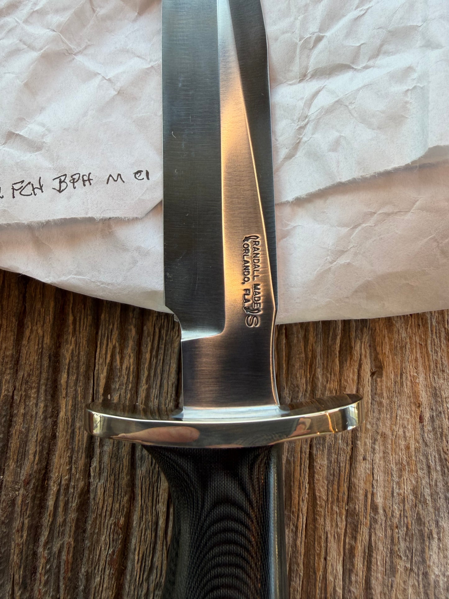 New in Paper Randall Model 16 SP#1 Special fighter with a Black Micarta handle. SS blade, Nickel silver Forward Curved hilt. Lanyard. Brown leather sheath.