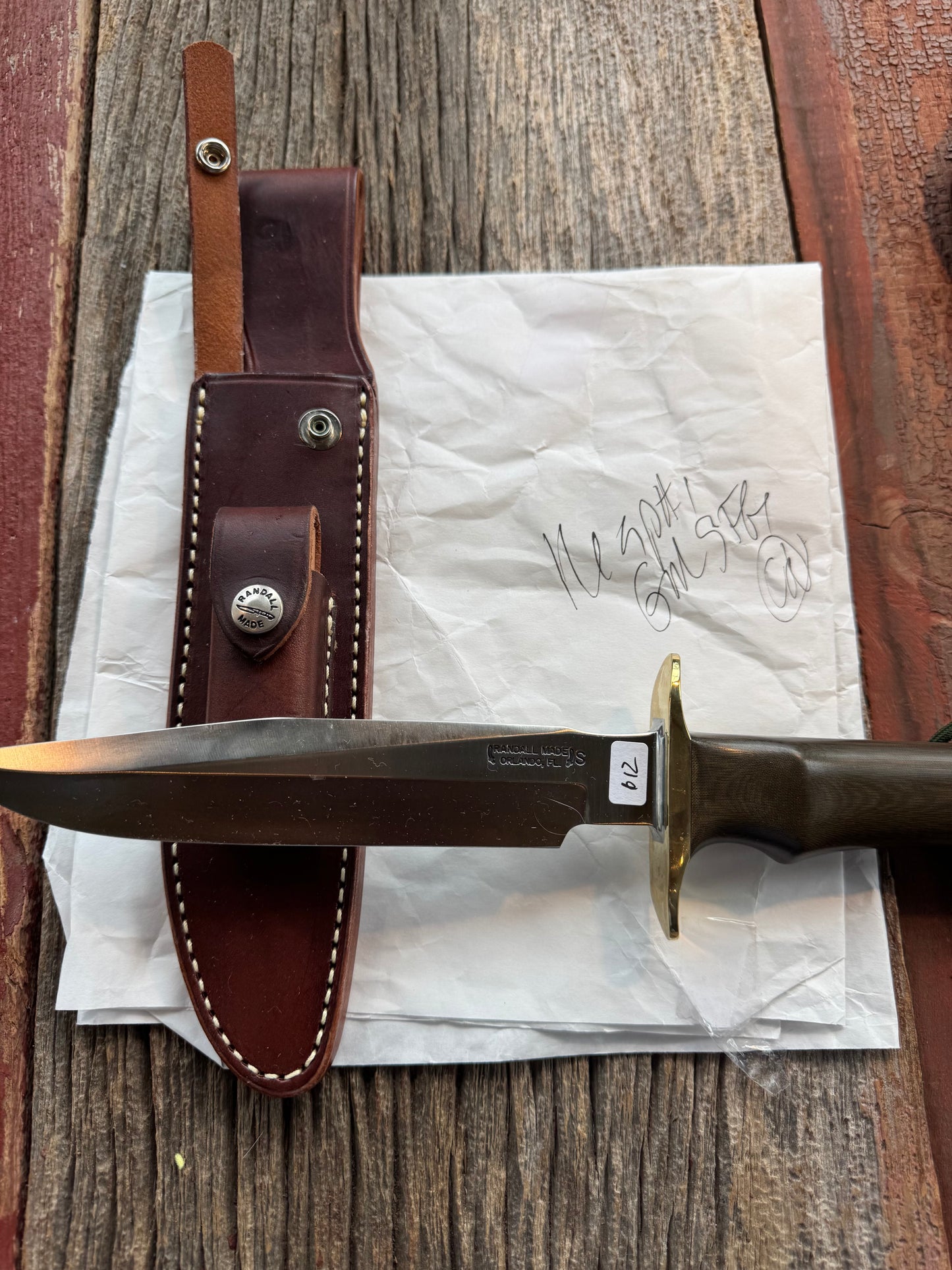 New in Paper Randall Model 16 SP#1 Special fighter with a Green Micarta handle. SS blade, Brass hilt. Lanyard. Brown leather sheath.