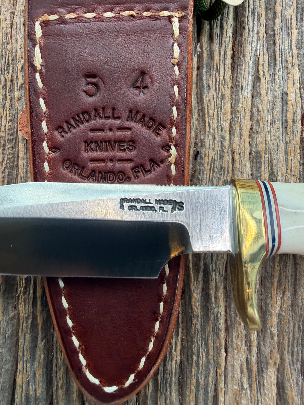 New Randall Model 5-4 with a Stag handle. Stainless steel blade, brass single hilt and natural butt. Red white and Blue spacers.