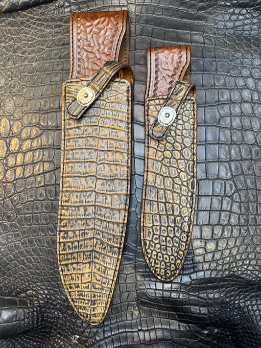 A pair of Randall Model 12-11 Large Sasquatch and Randall Model 12-8 Small Sasquatch Sheaths in Exotic Antique Brown Crocodile by Treeman.