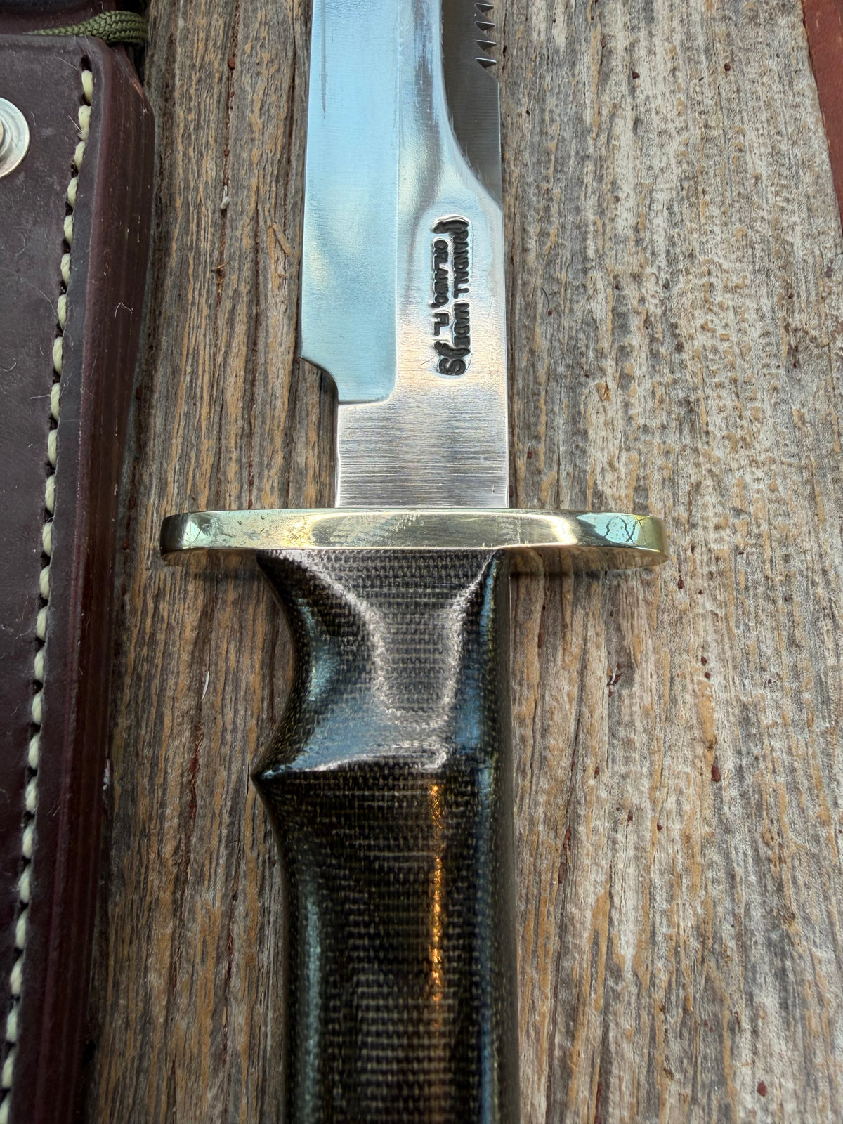 Nice Randall Model 16-7 with a glossy Brown Micarta handle. SS blade, double nickel silver hilt. Lanyard. Sawteeth, Brown waxed leather sheath.