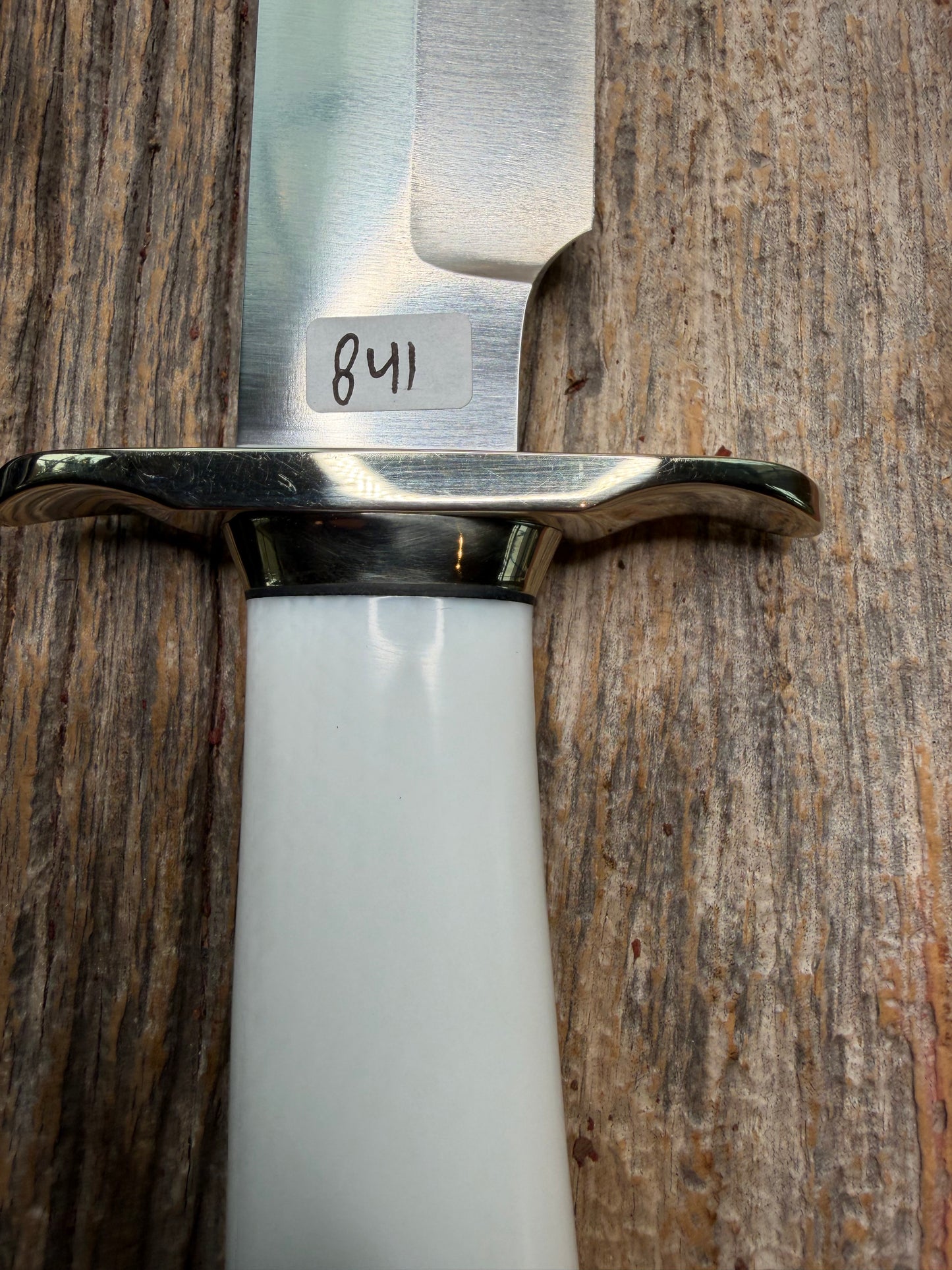 Randall Model 14-7.5 with a White Ivorite handle. Stainless steel blade, Nickel silver hilt and collar. Upgraded Black leather sheath.  Roundsd Aluminum butt cap.