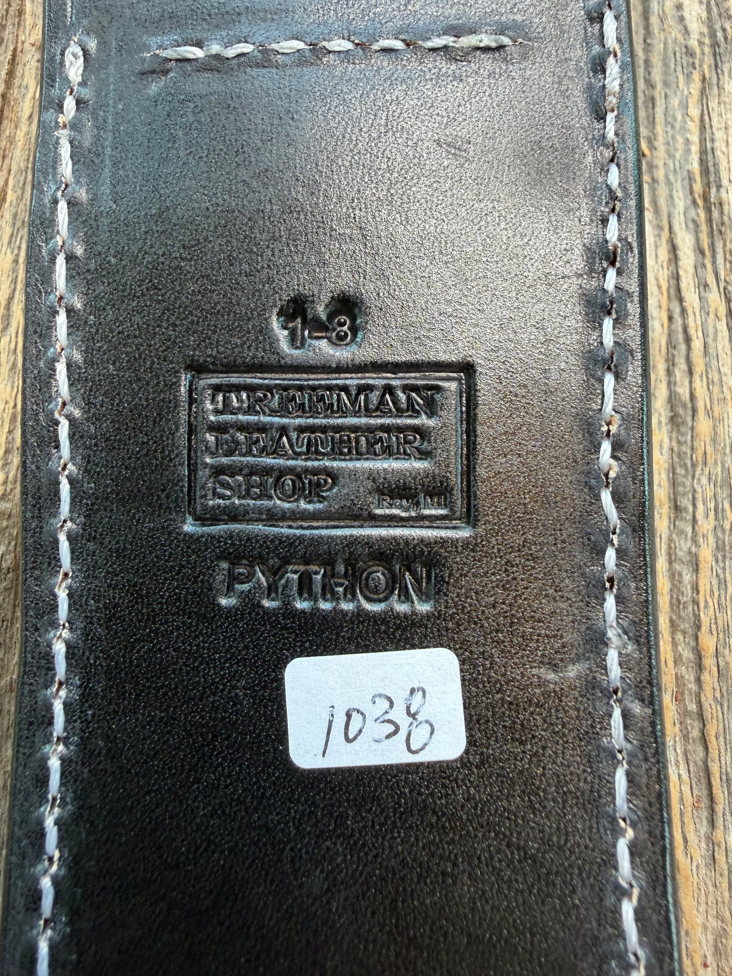 New Randall Model 1-8 Sheath in Exotic Brown Python Snake skin on black leather from Treeman with a black Canteen snap. Hand tooled belt loop. Deviated white stitching. Killer sheath.