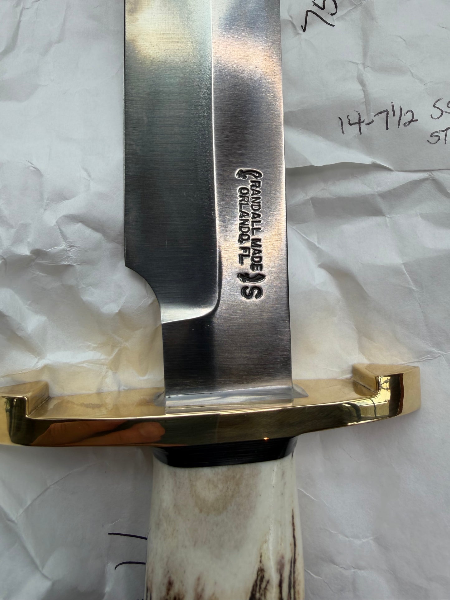New in paper fresh from the Shop. Randall Knife Model 14-7.5 Big. Nice piece of Stag, Gorgeous Brass Lugged hilt and brass crows beak butt cap. Single black spacer. Stainless steel.