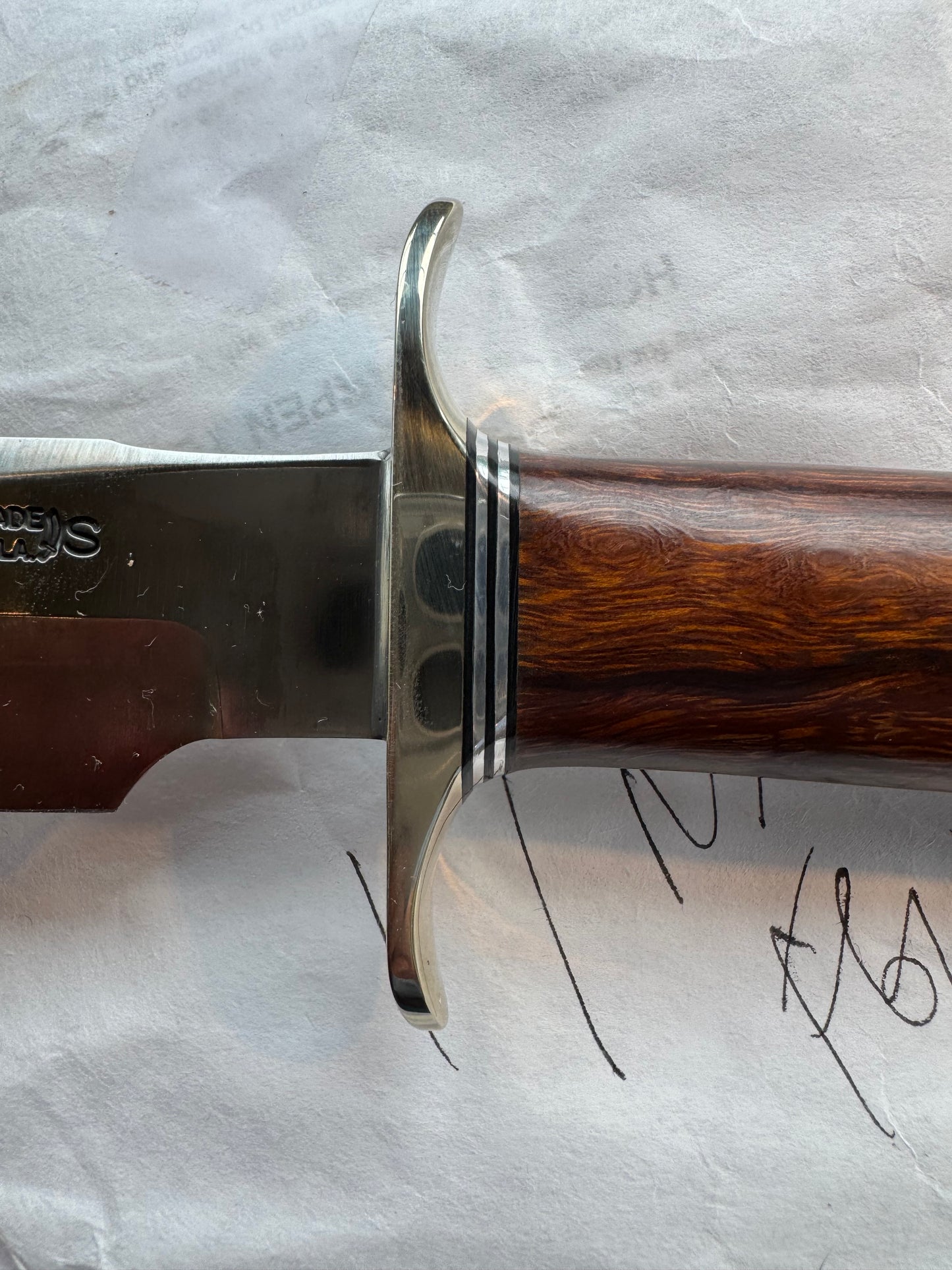 New in Paper Randall Model 1-7 Stainless steel blade, Nickel silver hilt and butt cap. Brown leather sheath. Burl wood handle.