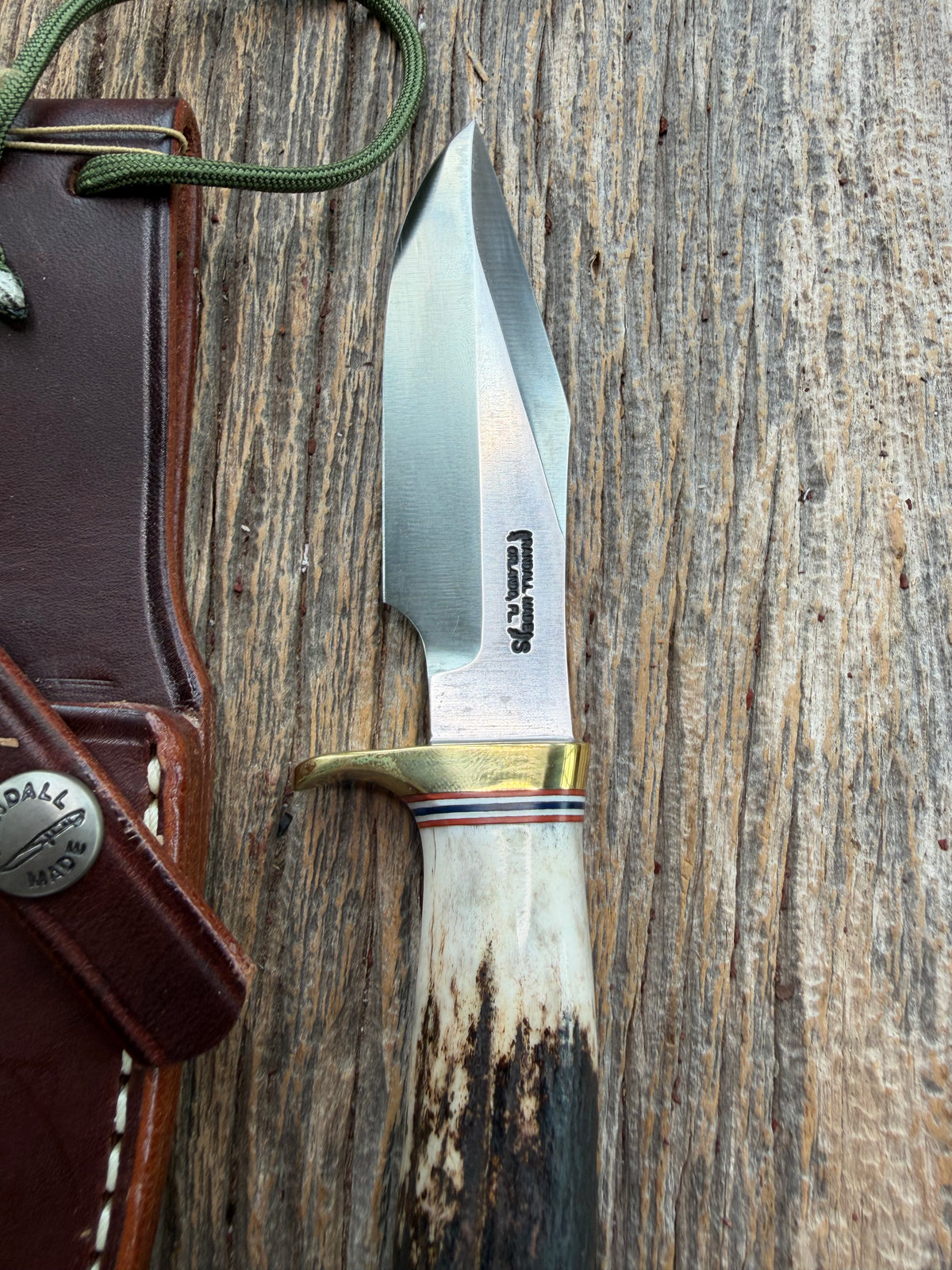 New Randall Model 8-4 with a Stag handle. Stainless steel blade, brass single hilt and natural butt. Red white and Blue spacers.