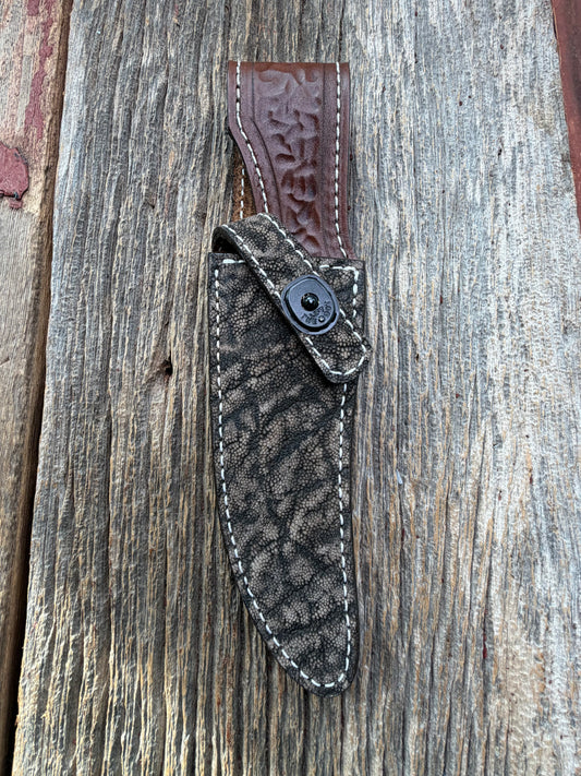 New Randall Model 27 Sheath in Exotic thick and textured Black and Grey Elephant Ear  on brown leather from Treeman with a black Canteen snap. Hand tooled belt loop. Killer sheath.