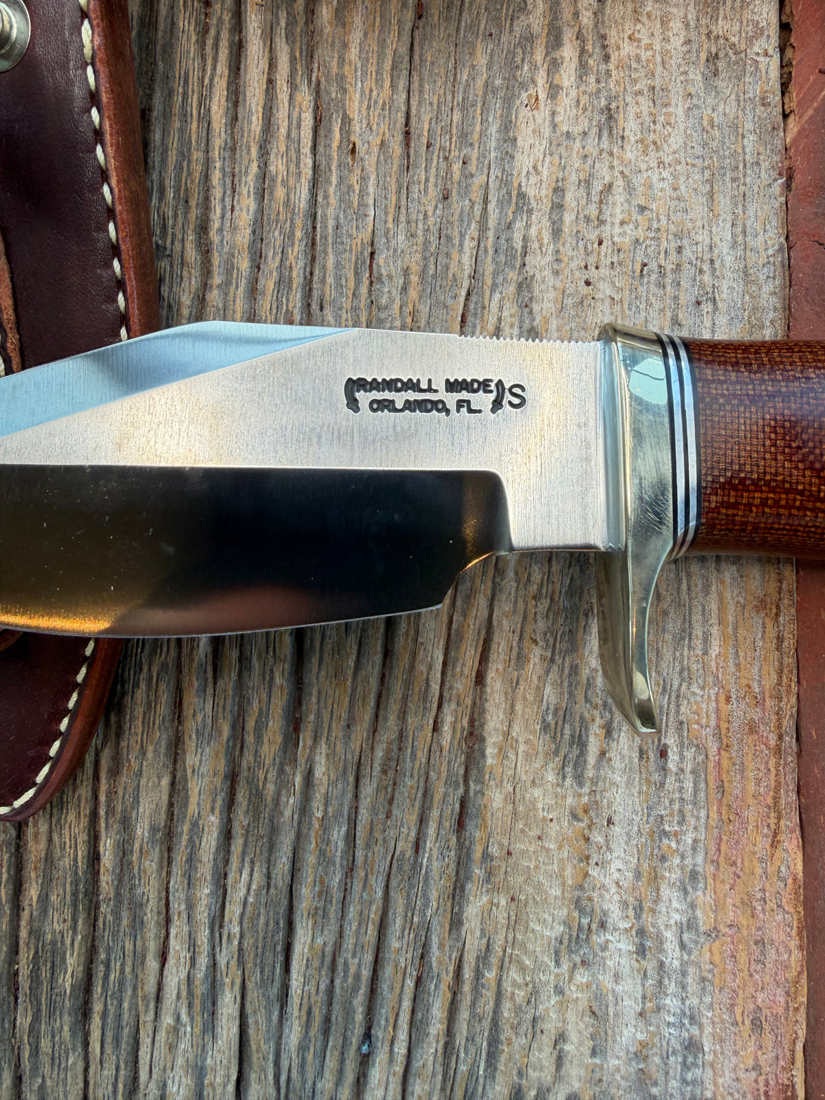 New in Paper Randall Model 19-5 with an attractive piece of Brown Micarta. Nickel silver single Hilt and buttcap , Stainless steel. Black and Aluminum spacers.