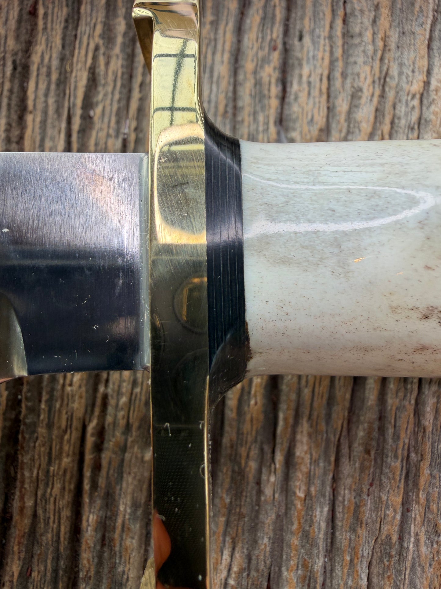 New in paper fresh from the Shop. Randall Knife Model 14-7.5 Big. Nice piece of Stag, Gorgeous Brass Lugged hilt and brass crows beak butt cap. Single black spacer. Stainless steel.