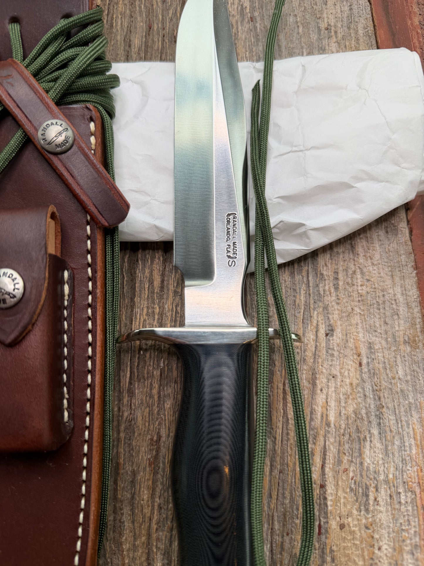New in Paper Randall Model 16 SP#1 Special fighter with a Black Micarta handle. SS blade, Nickel silver hilt. Lanyard. Brown leather sheath.