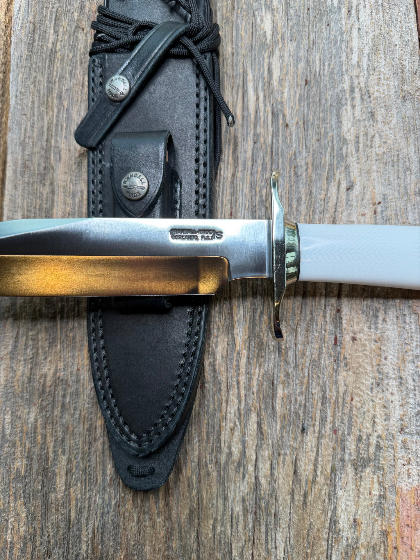 Randall Model 14-7.5 with a White Ivorite handle. Stainless steel blade, Nickel silver hilt and collar. Upgraded Black leather sheath.  Roundsd Aluminum butt cap.