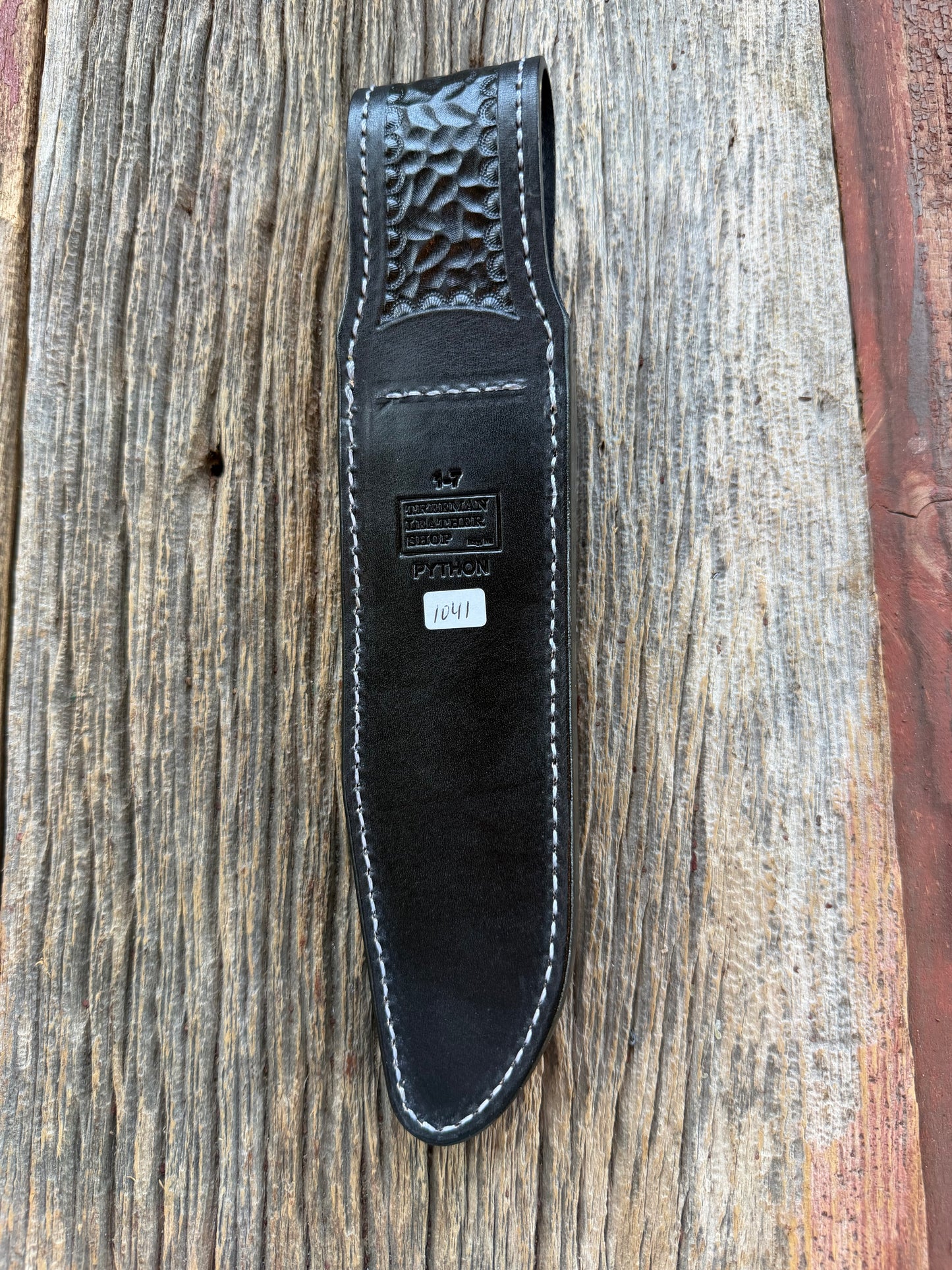 New Randall Model 1-7 Sheath in Exotic Brown Python Snake skin on black leather from Treeman with a black Canteen snap. Hand tooled belt loop. Deviated white stitching. Killer sheath.