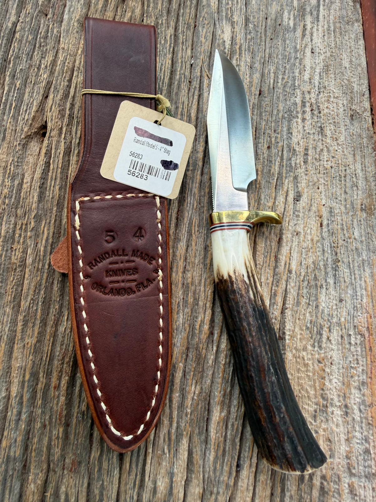 New Randall Model 5-4 with a Stag handle. Stainless steel blade, brass single hilt and natural butt. Red white and Blue spacers.