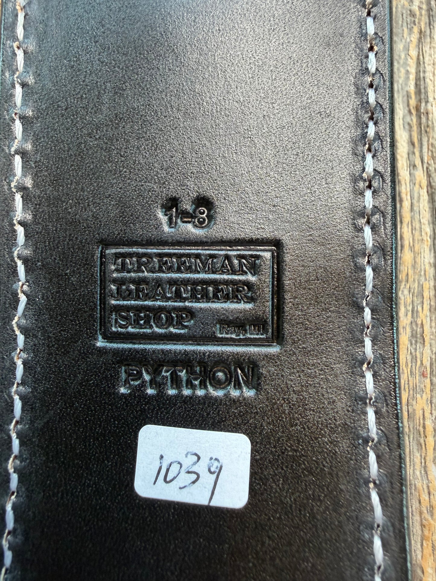 New Randall Model 1-8 Sheath in Exotic Brown Python Snake skin on black leather from Treeman with a black Canteen snap. Hand tooled belt loop. Deviated white stitching. Killer sheath.