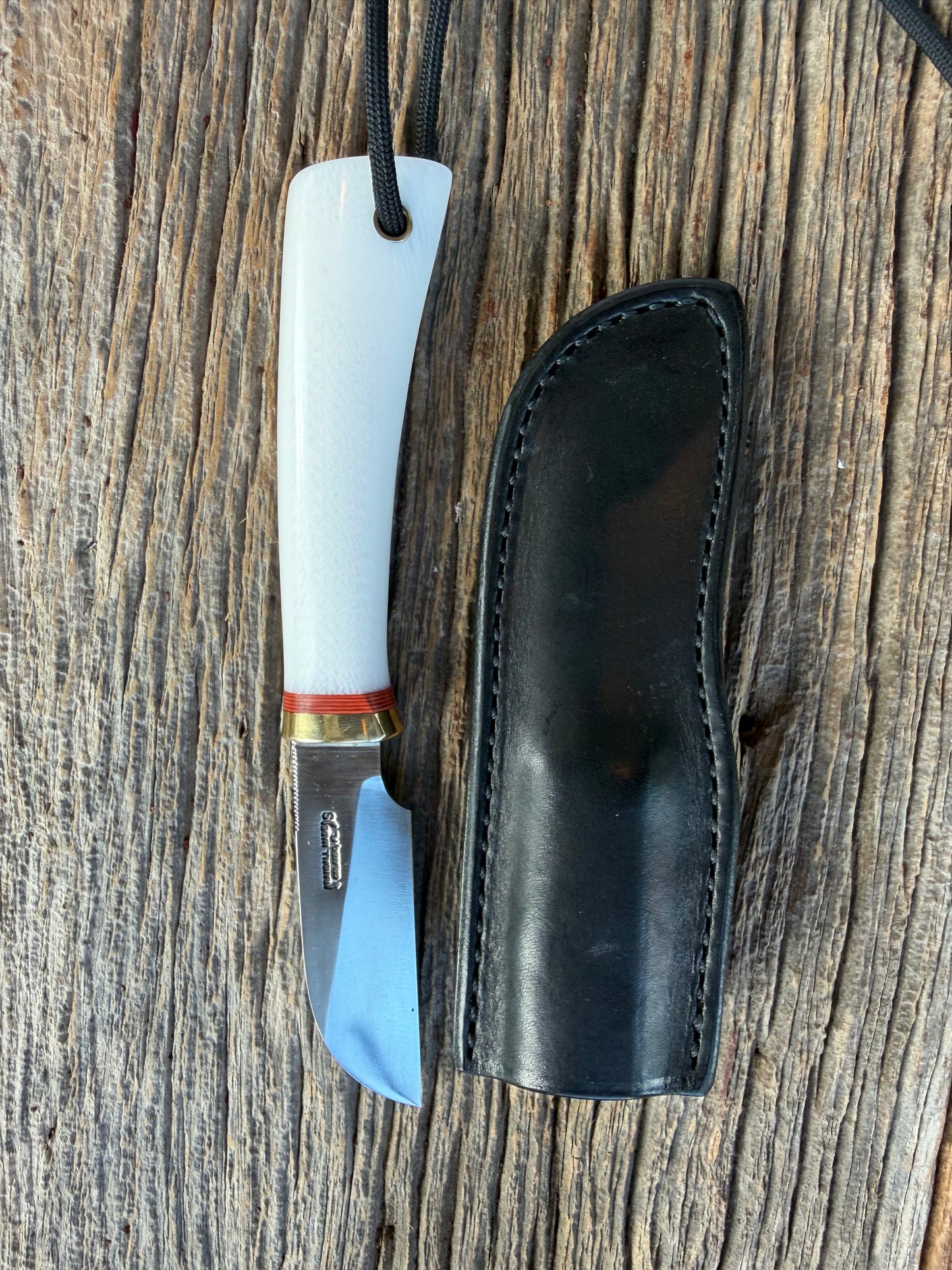 New in Paper Randall Non Catalog Model  Cattleman. White Ivorite handle. Red and silver spacers. Stainless blade.