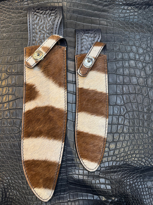 A pair of Randall Model 12-11 Large Sasquatch and Randall Model 12-8 Small Sasquatch Sheaths in Exotic Zebra by Treeman.