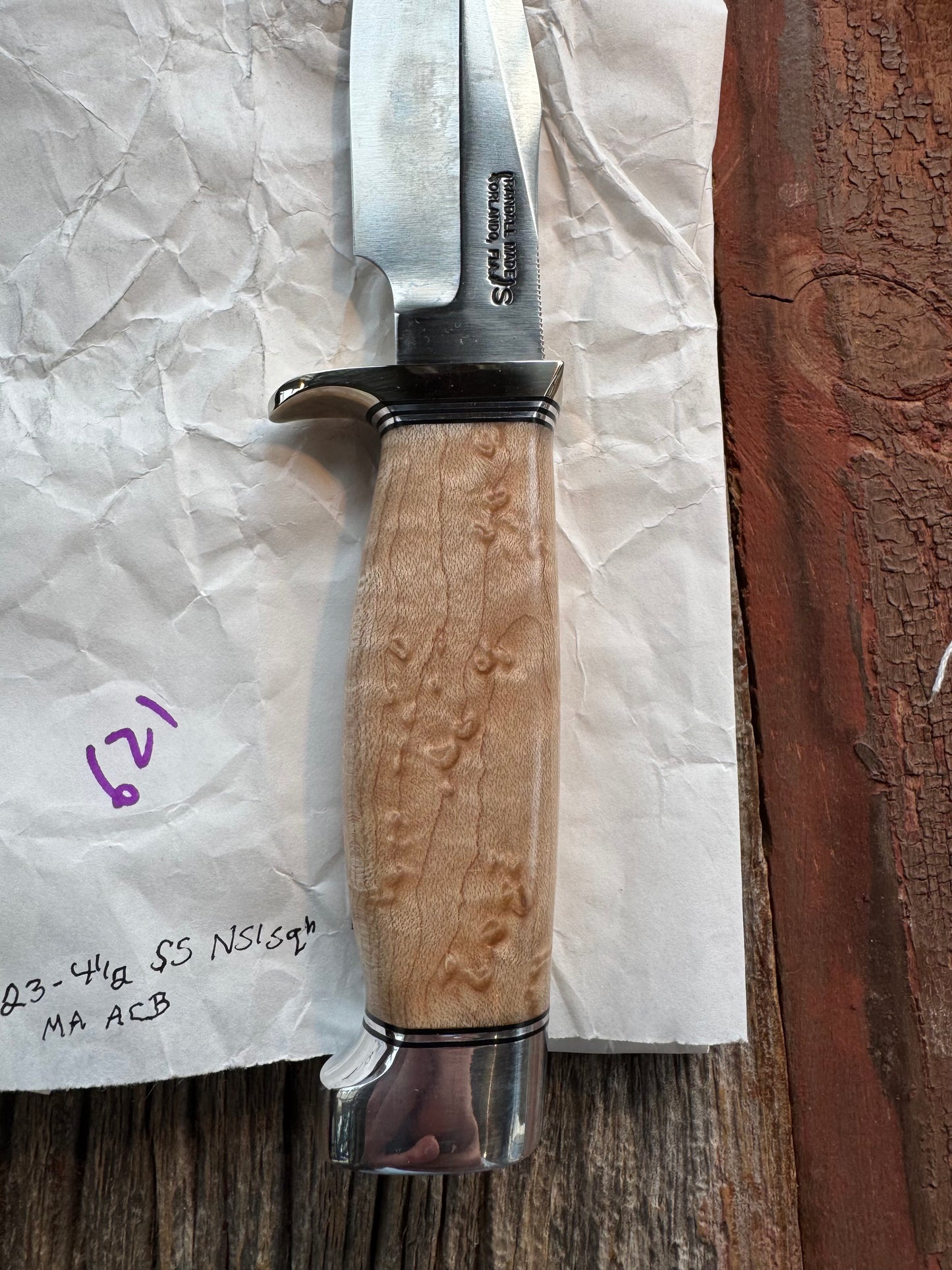 New in Paper Randall Model 23 Game Master Stainless steel blade, Nickel silver hilt and aluminum butt cap. Brown leather sheath. Maple wood handle.