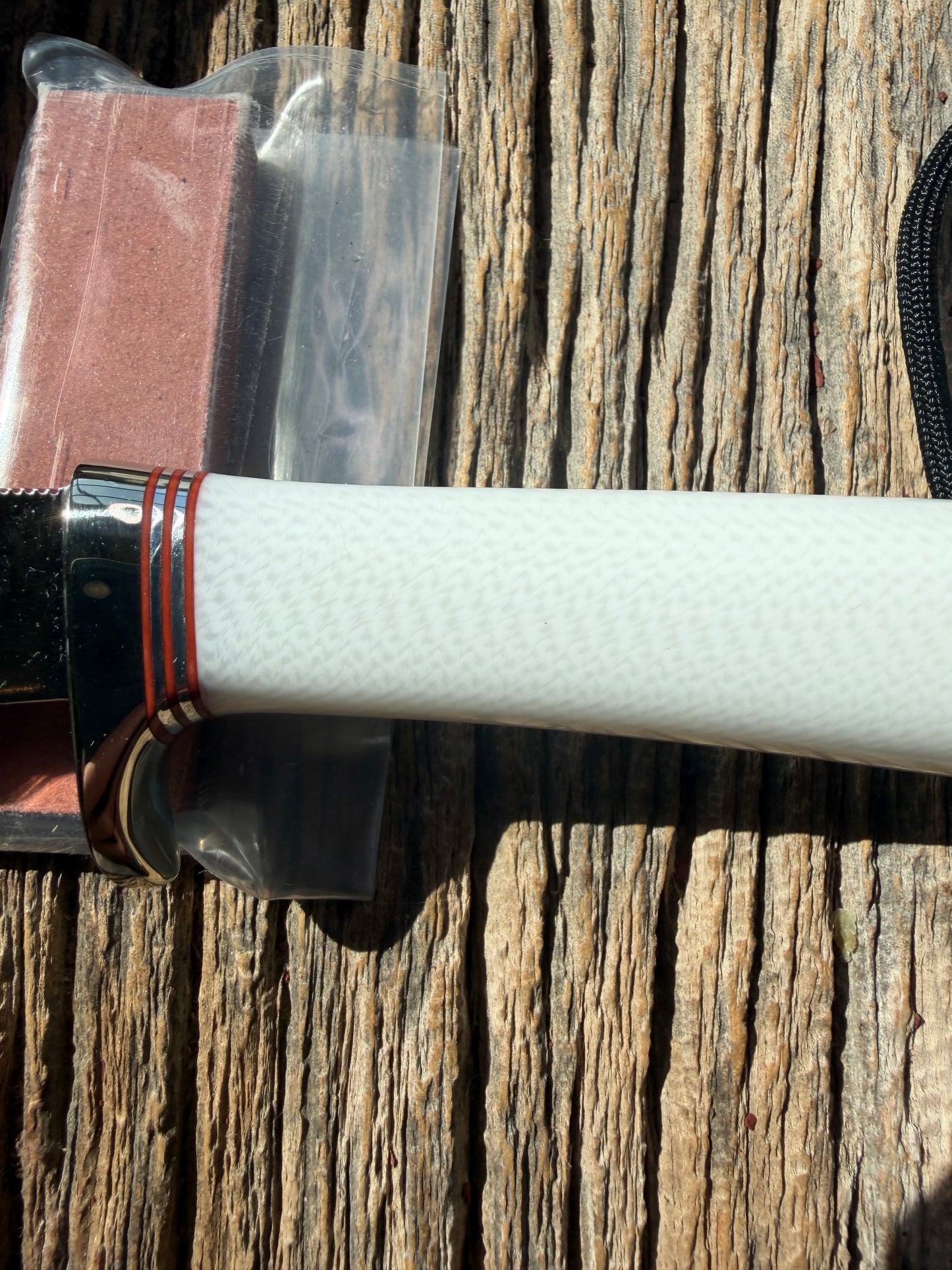New in Paper Randall Non Catalog Model  Cattleman. White Ivorite handle. Red and silver spacers. Stainless blade.