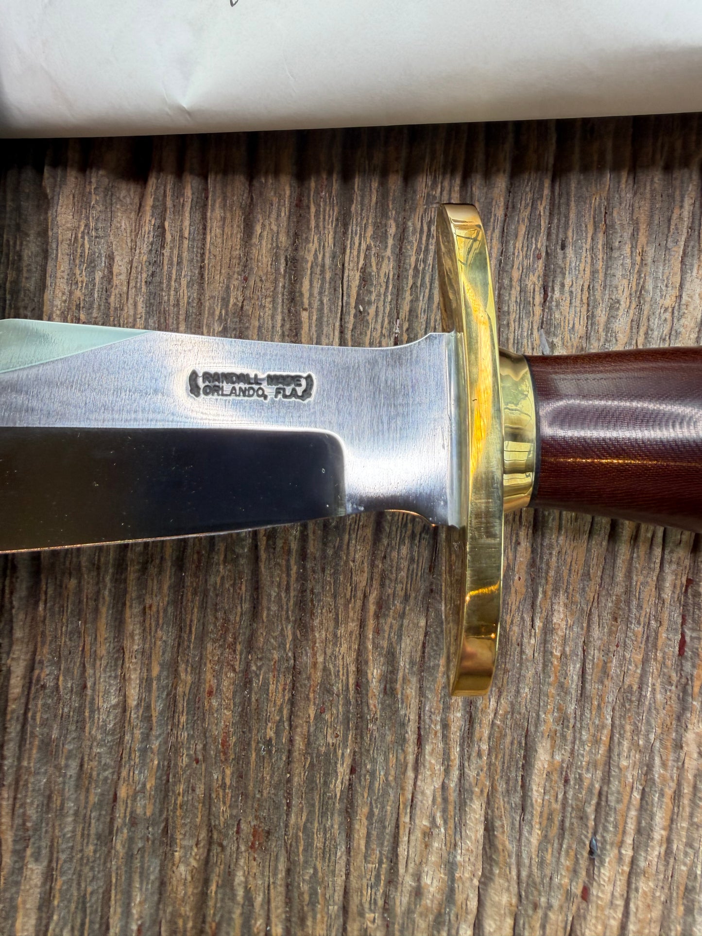 New in Paper Randall Model 12-8 Big Bear with a Maroon Micarta handle. Brass Hilt  and Brass collar, Carbon steel, brass butt cap.