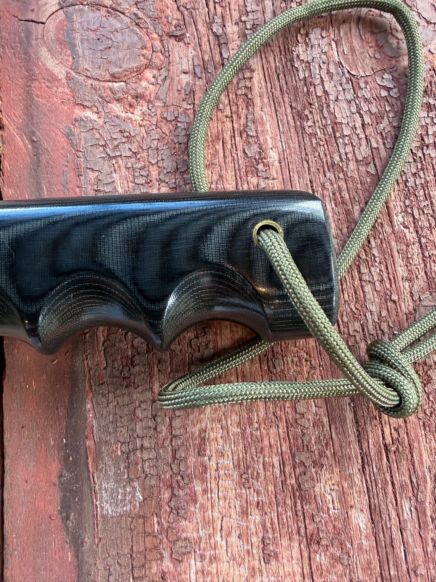 Randall Model 14-7.5 with a Black Micarta finger grooved handle. Carbon steel blade, Brass double hilt brown leather sheath.