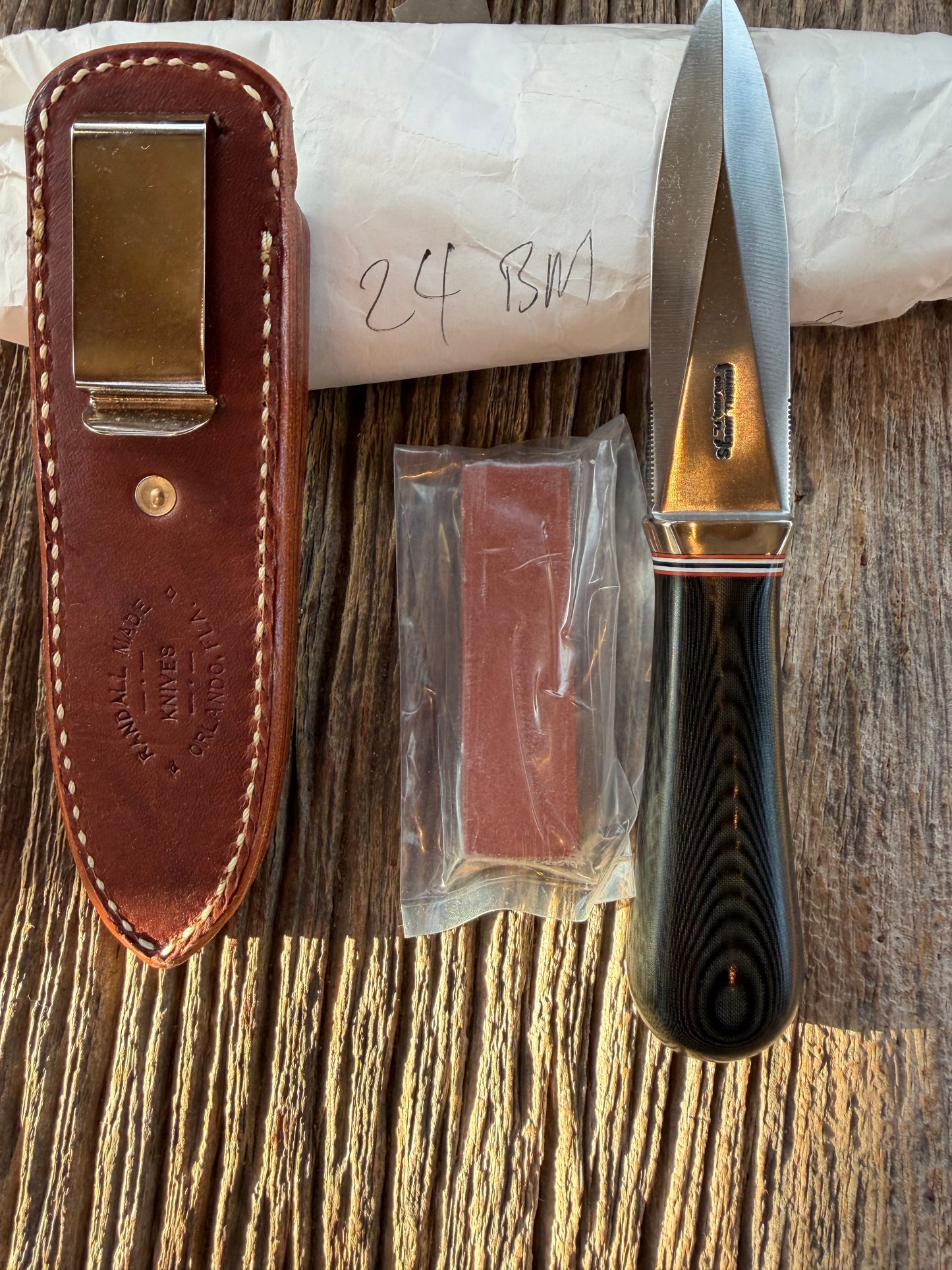 New in Paper Randall Model 24 Guardian in Black Micarta Nickel hilt, Stainless, red white blue spacers.
