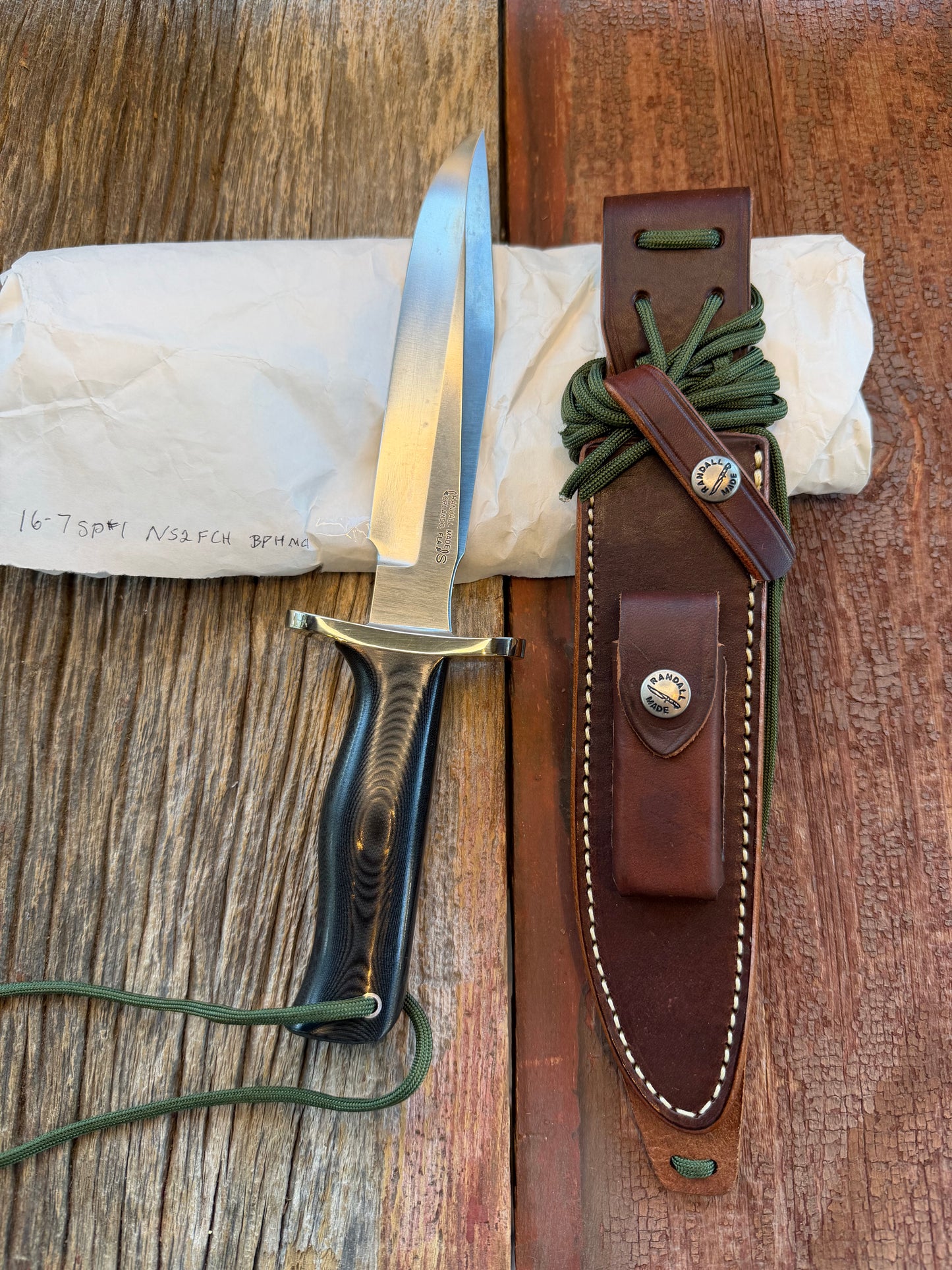 New in Paper Randall Model 16 SP#1 Special fighter with a Black Micarta handle. SS blade, Nickel silver Forward Curved hilt. Lanyard. Brown leather sheath.