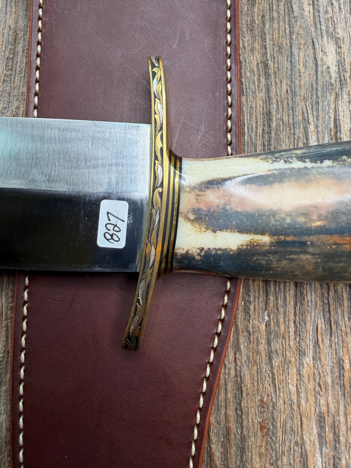 Randall Model 12-11 Smithsonian “Smitty” in a Huge piece of Green, Brown and Blue Fossil Walrus Ivory. Brass Hilt and Brass Butt plate fully engraved in Silver from Jere Davidson.  Stunning piece.