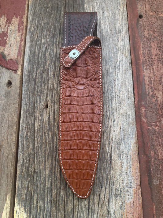 New Randall Model 12-11 Large Sasquatch Sheath in Exotic thick and textured Honey Crocodile skin ( skull portion) on brown leather from Treeman with a silver Canteen snap. Hand tooled belt loop. Killer sheath.