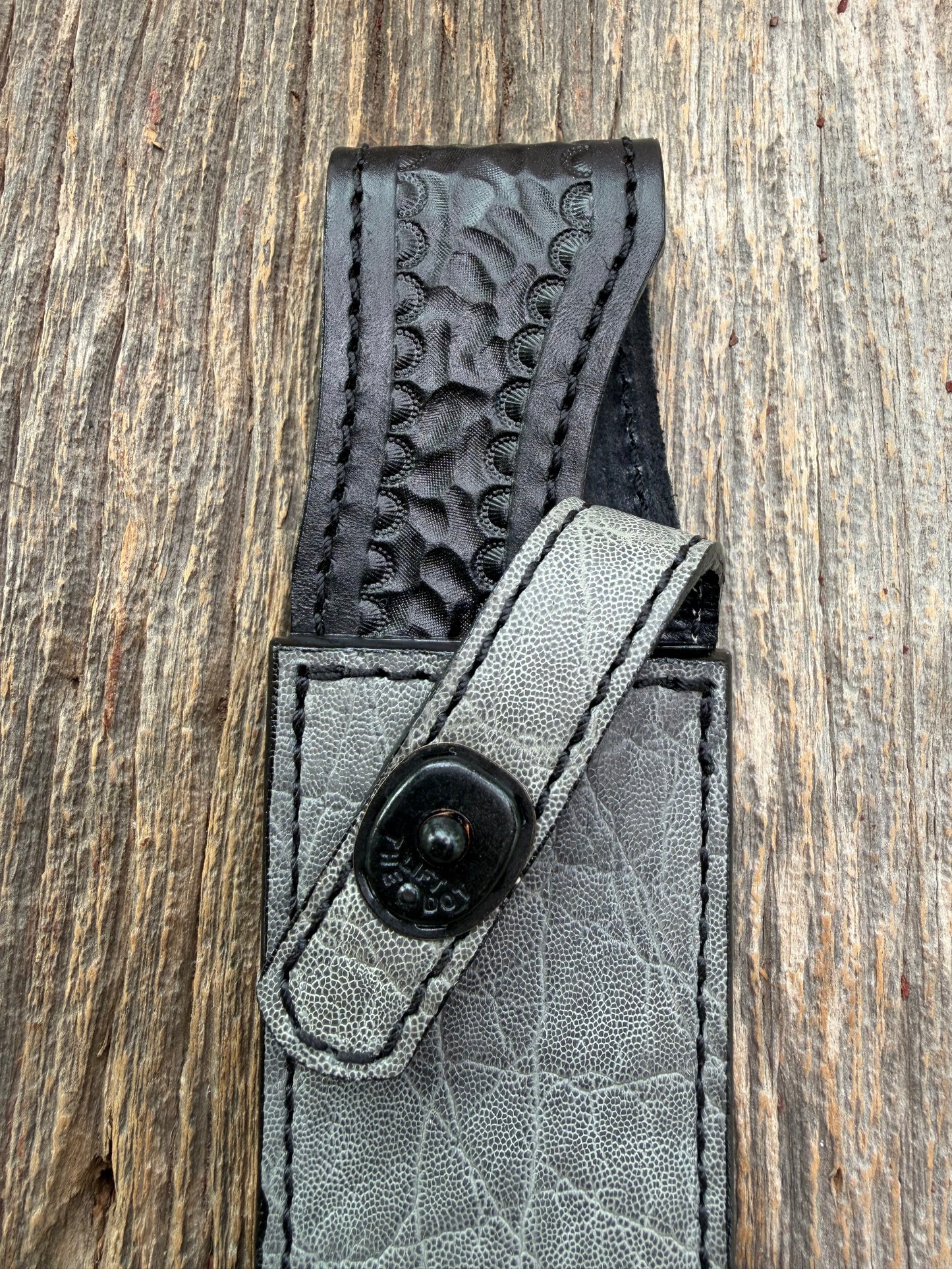 New Randall Model 1-8 Sheath in Exotic thick and textured Grey Elephant Hide on black leather from Treeman with a black Canteen snap. Hand tooled belt loop. Killer sheath.