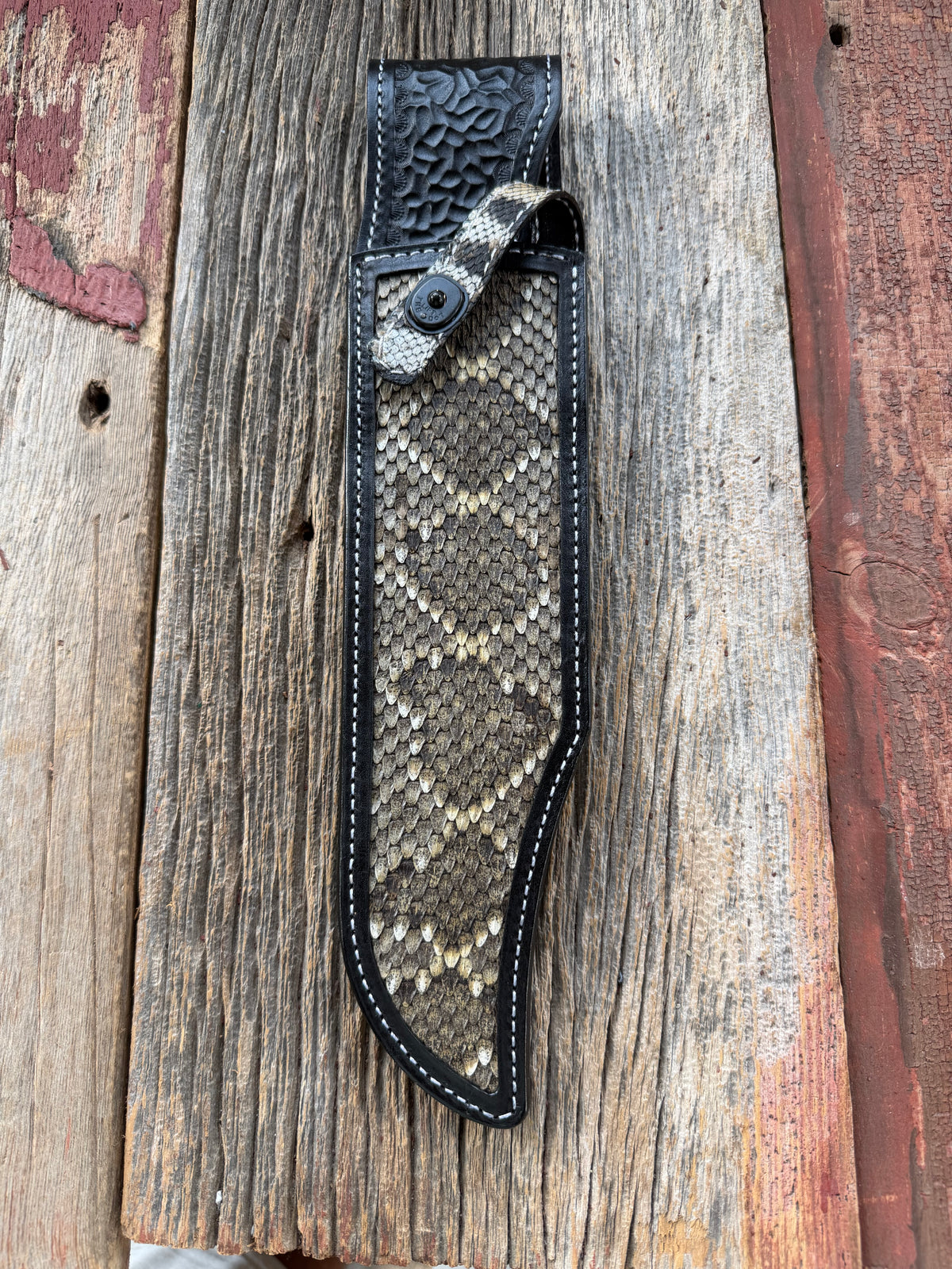 Randall Model Smithsonian sheath with a Western Diamondback RattleSnake skin inlay from Treeman Sheaths. Very dark skin, white thread deviated stitching, black canteen snap.