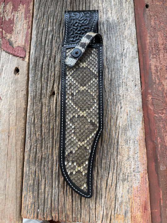 Randall Model Smithsonian sheath with a Western Diamondback RattleSnake skin inlay from Treeman Sheaths. Very dark skin, white thread deviated stitching, black canteen snap.