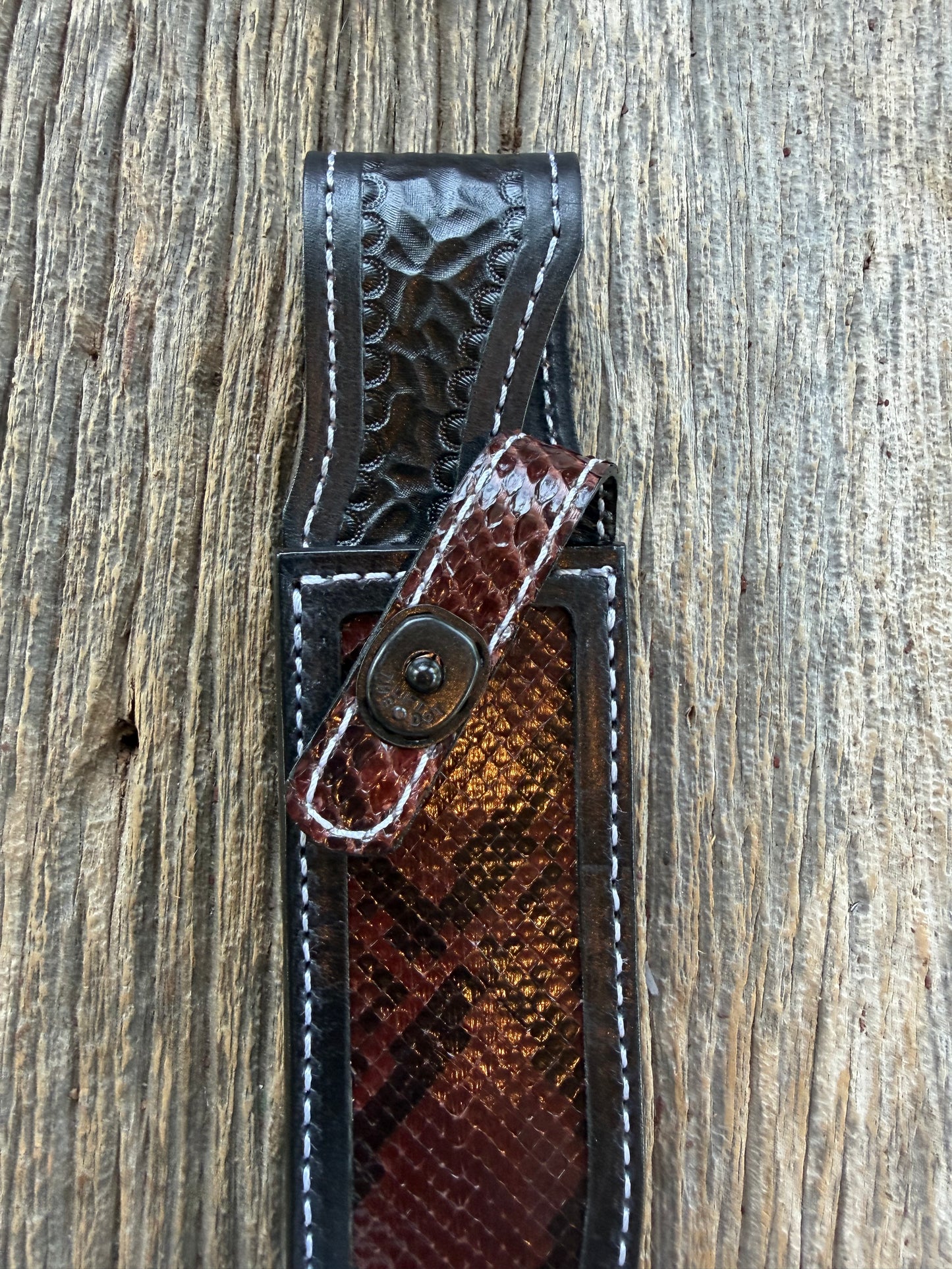 New Randall Model 1-7 Sheath in Exotic Brown Python Snake skin on black leather from Treeman with a black Canteen snap. Hand tooled belt loop. Deviated white stitching. Killer sheath.