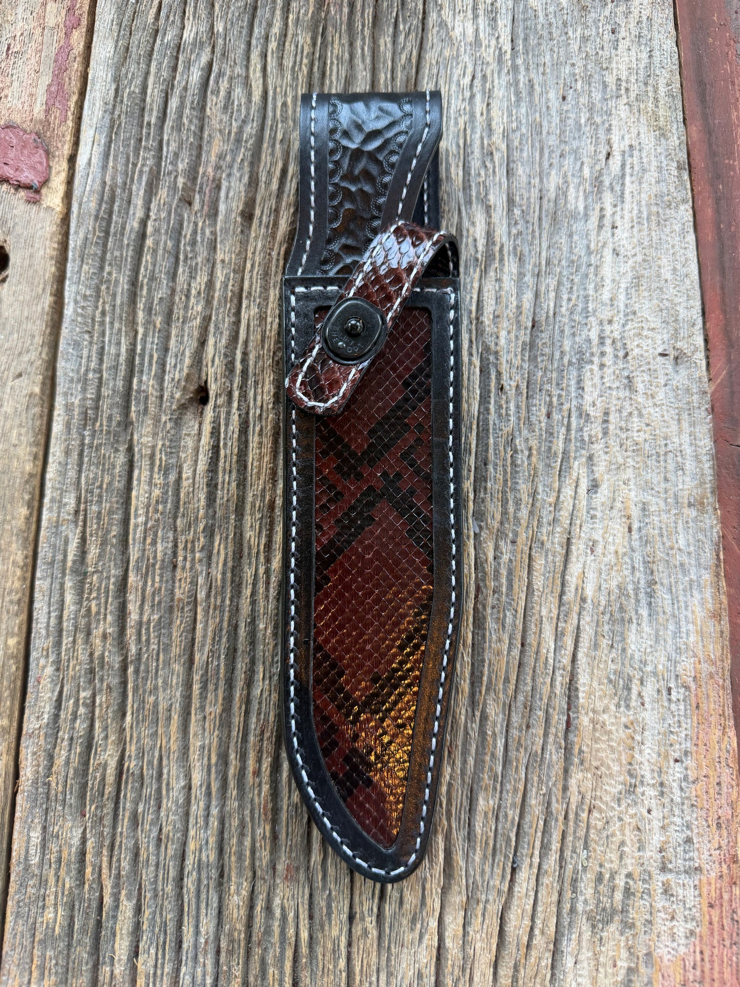 New Randall Model 1-7 Sheath in Exotic Brown Python Snake skin on black leather from Treeman with a black Canteen snap. Hand tooled belt loop. Deviated white stitching. Killer sheath.