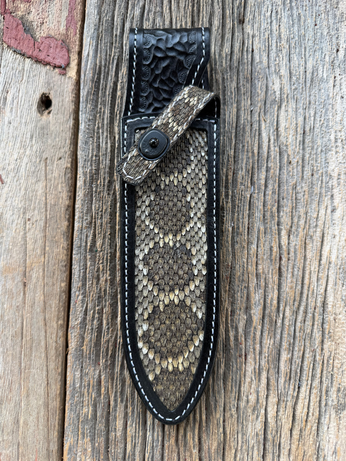 Randall Model Clinton Special sheath with inlayed Western Diamondback RattleSnake skin from Treeman Sheaths. Very dark skin on brown leather, white deviated stitching and black canteen snaps.