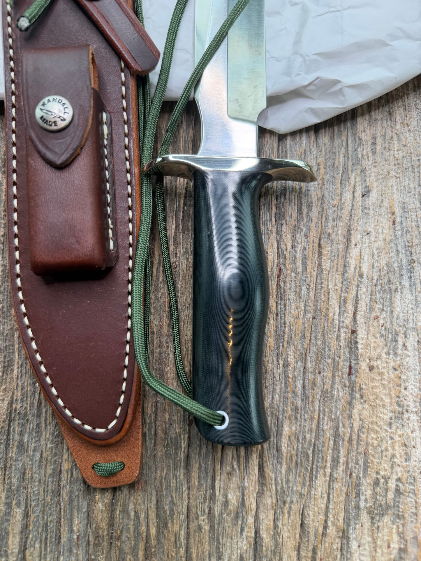 New in Paper Randall Model 16 SP#1 Special fighter with a Black Micarta handle. SS blade, Nickel silver hilt. Lanyard. Brown leather sheath.