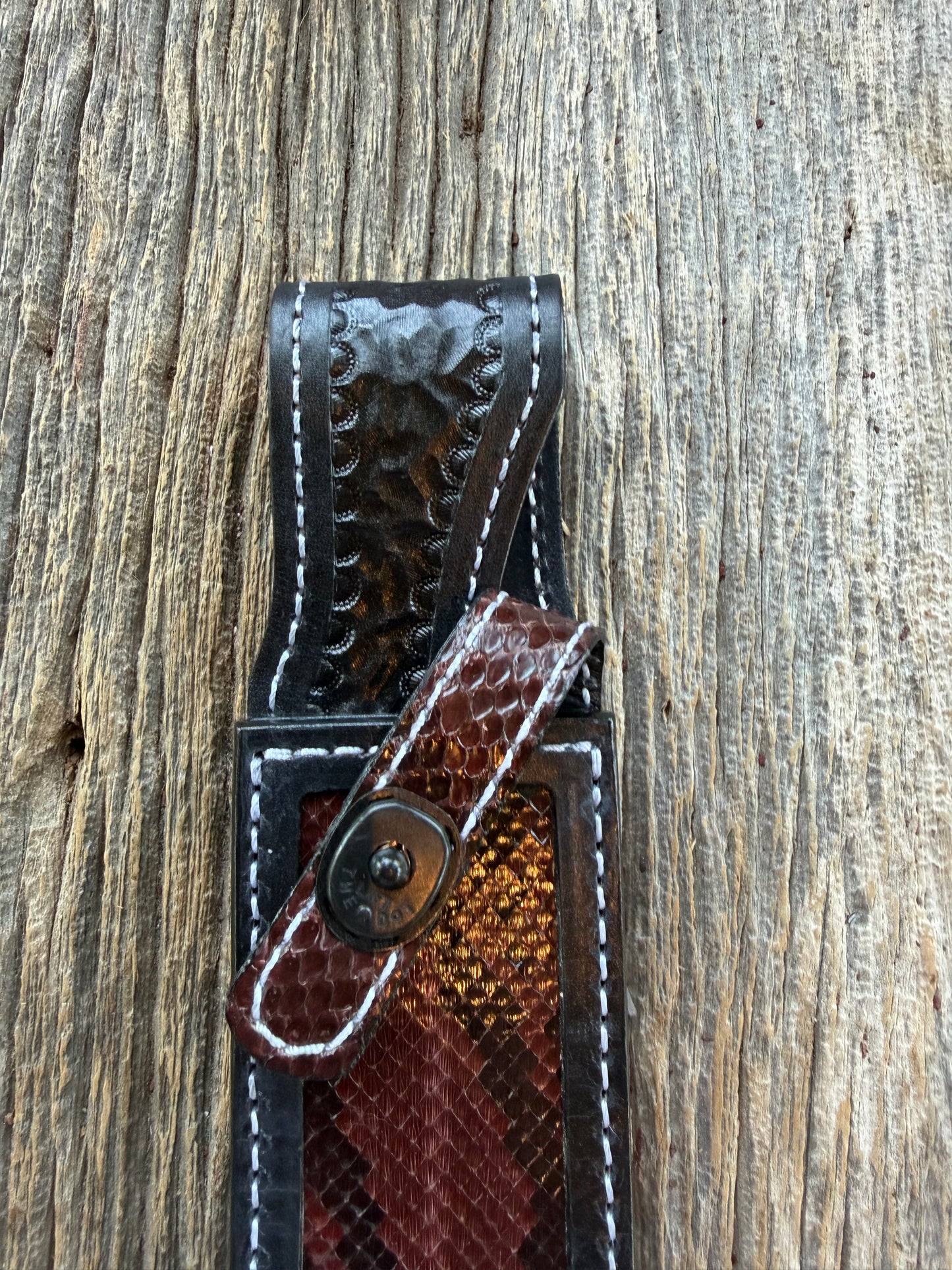 New Randall Model 1-7 Sheath in Exotic Brown Python Snake skin on black leather from Treeman with a black Canteen snap. Hand tooled belt loop. Deviated white stitching. Killer sheath.
