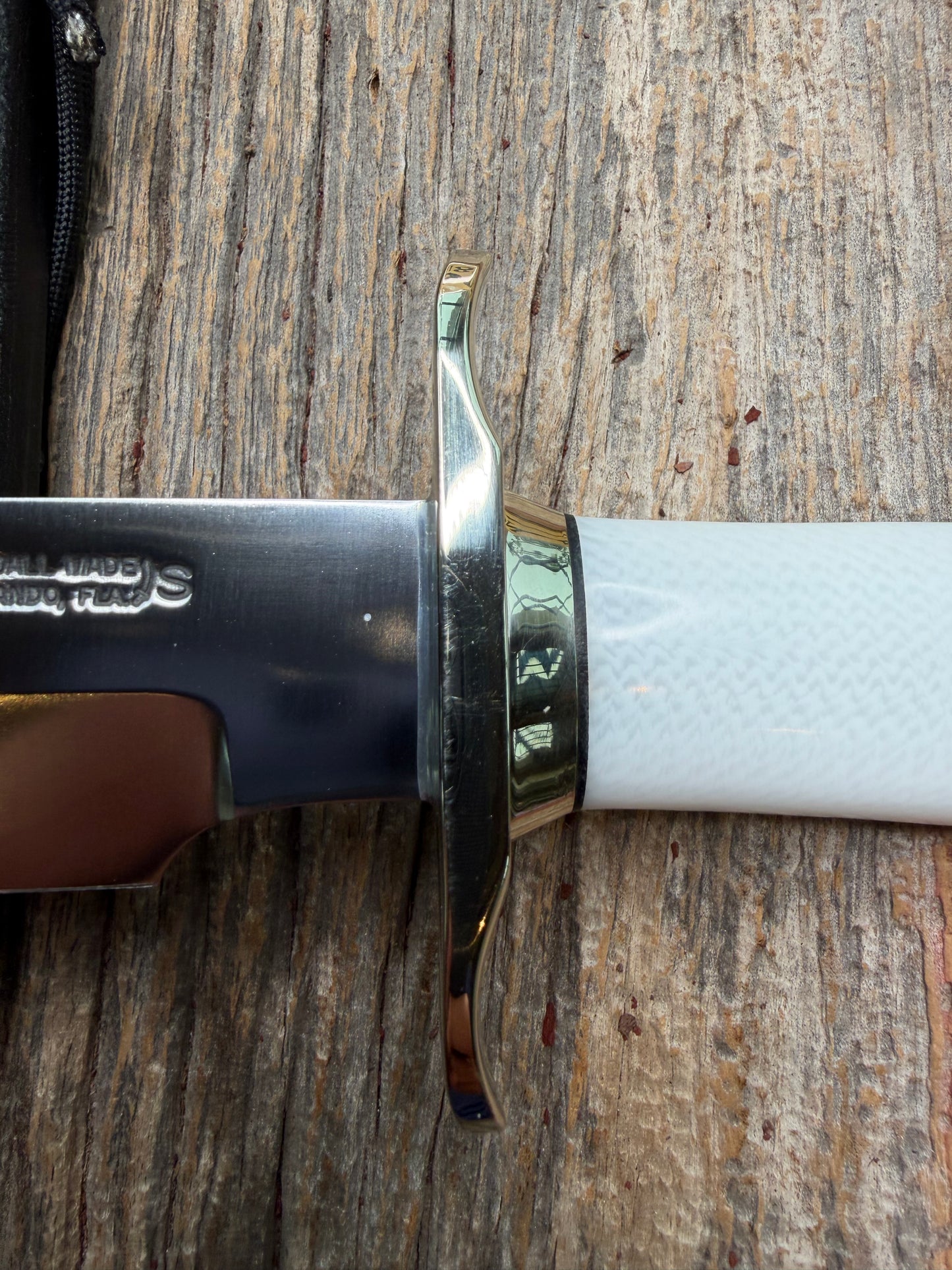 Randall Model 14-7.5 with a White Ivorite handle. Stainless steel blade, Nickel silver hilt and collar. Upgraded Black leather sheath.  Roundsd Aluminum butt cap.
