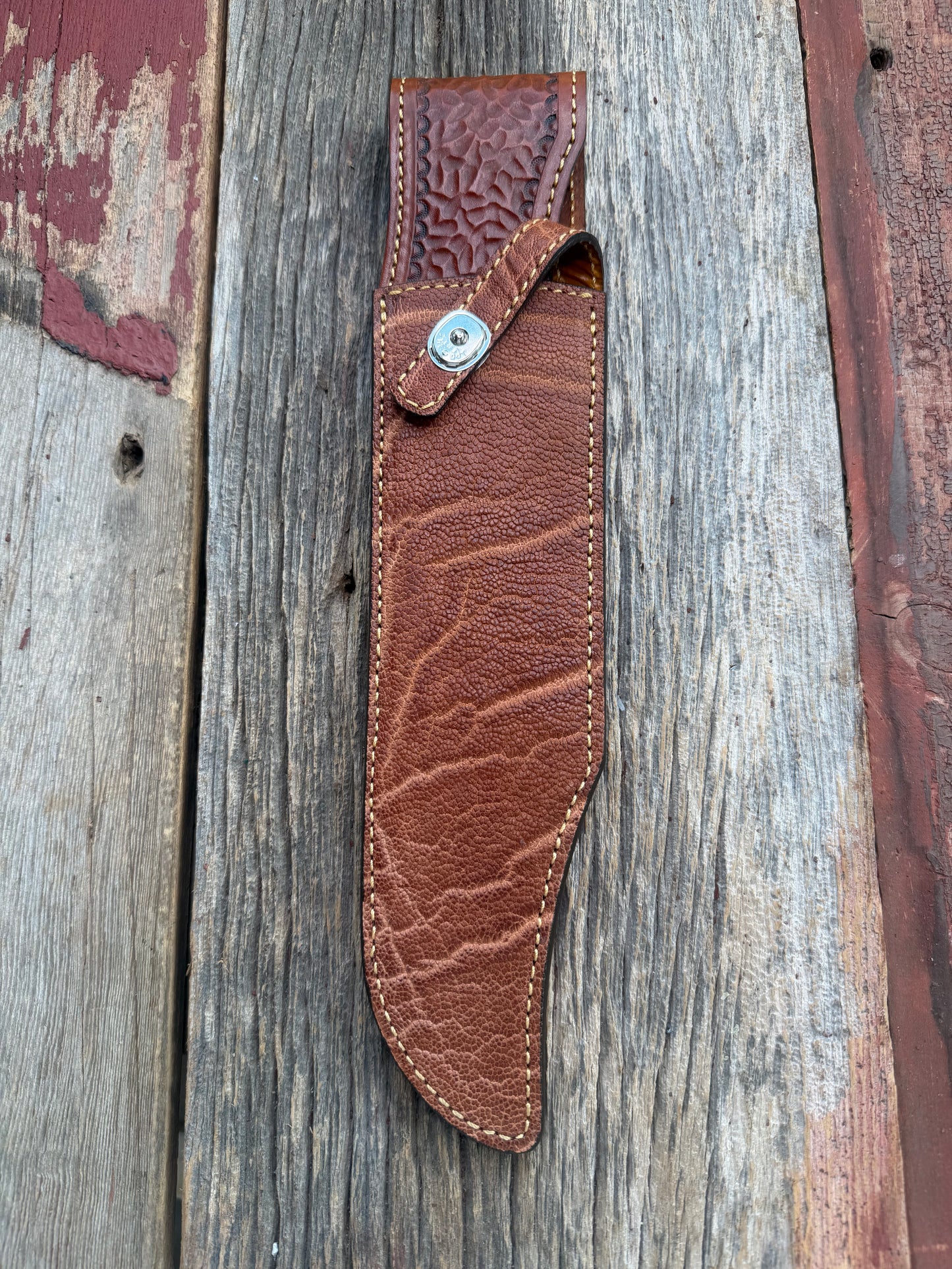 New Randall Model 12-11 Smithsonian Sheath in Exotic thick and textured Rust colored Elephant hide on brown leather from Treeman with a silver Canteen snap. Hand tooled belt loop. Killer sheath.