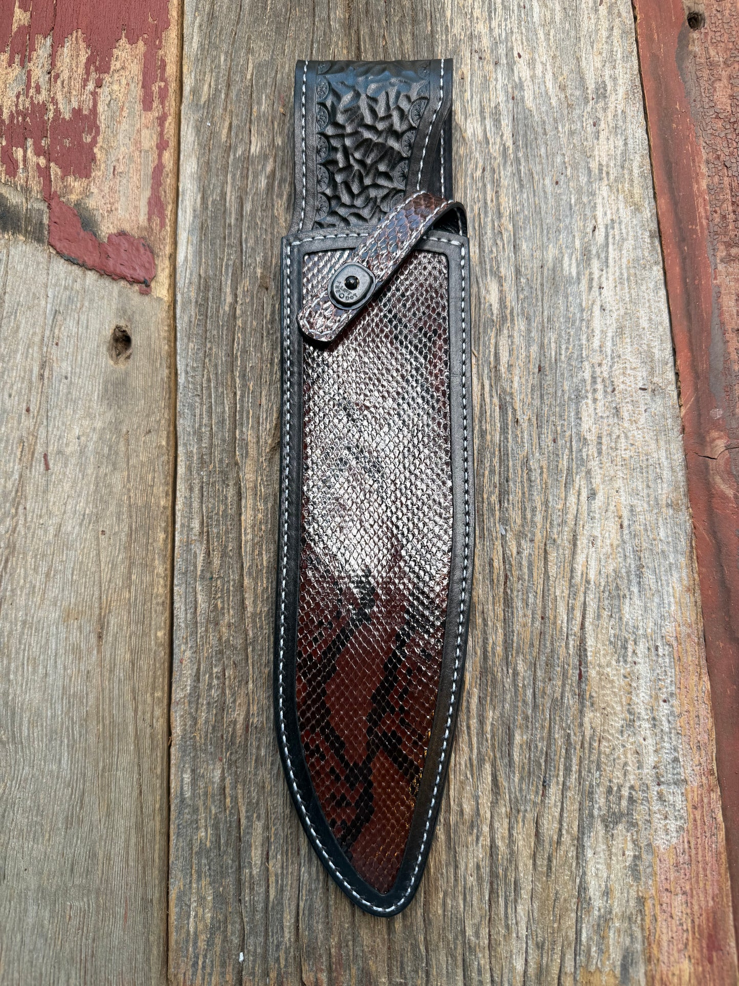 New Randall Model 12-11 Large Sasquatch Sheath in Exotic Brown Python Snake on black leather from Treeman with a black Canteen snap. Hand tooled belt loop. Deviated white stitching. Killer sheath.