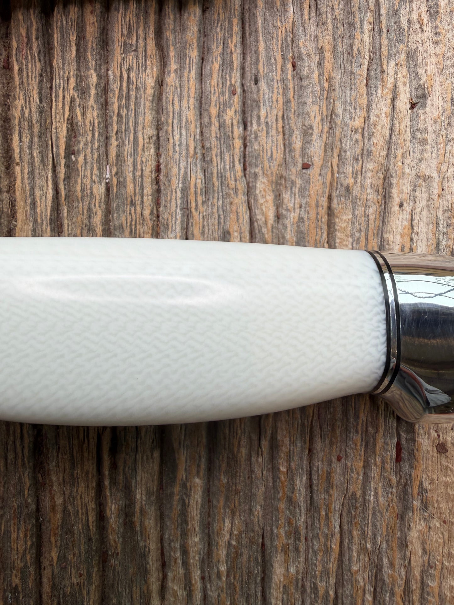 New in Paper Randall Model 19-5 Bushmaster with a White Ivorite handle. Stainless steel blade, Nickel silver hilt. Upgraded Black leather sheath. Crows Beak Aluminum handle.