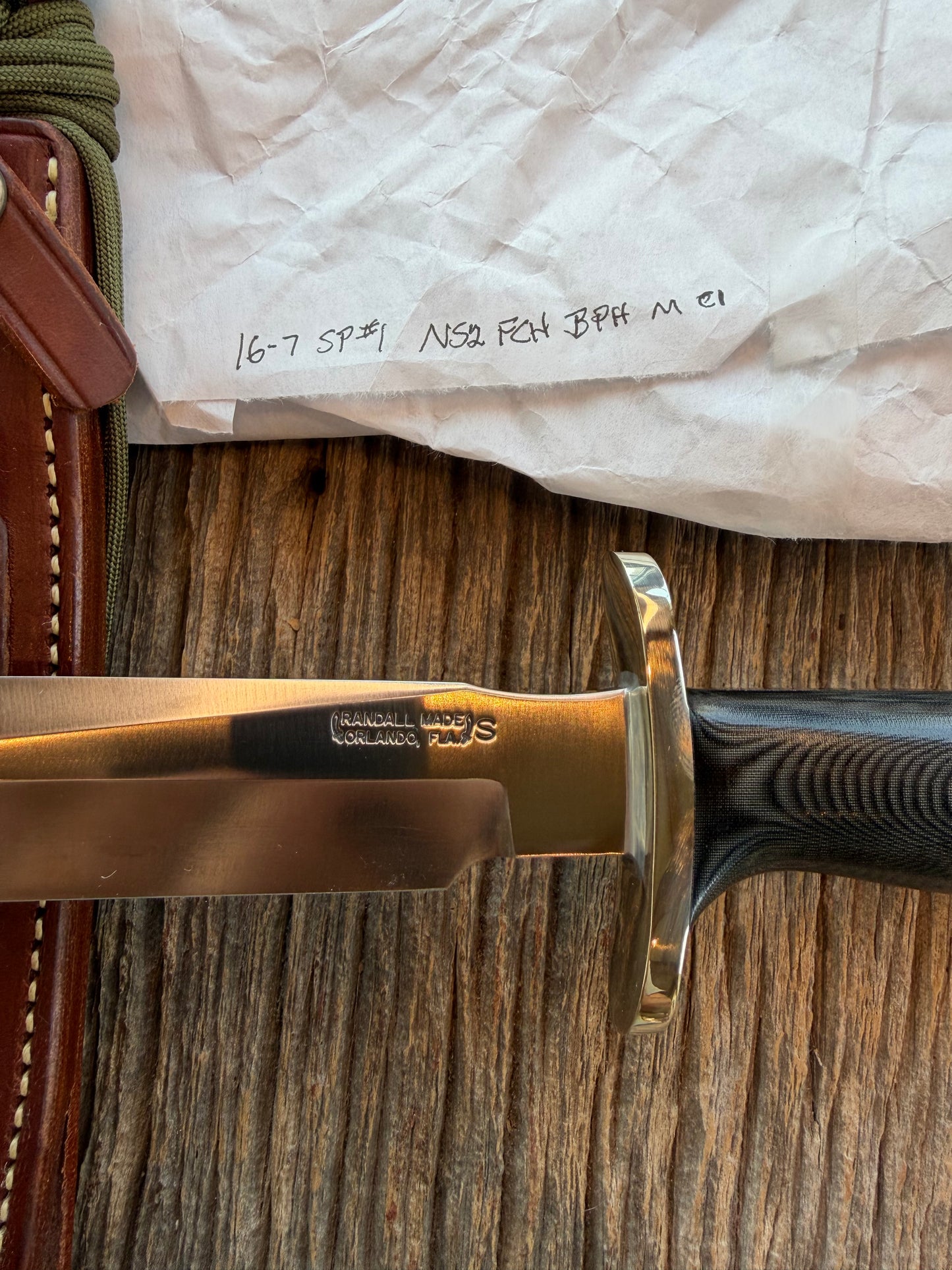New in Paper Randall Model 16 SP#1 Special fighter with a Black Micarta handle. SS blade, Nickel silver Forward Curved hilt. Lanyard. Brown leather sheath.