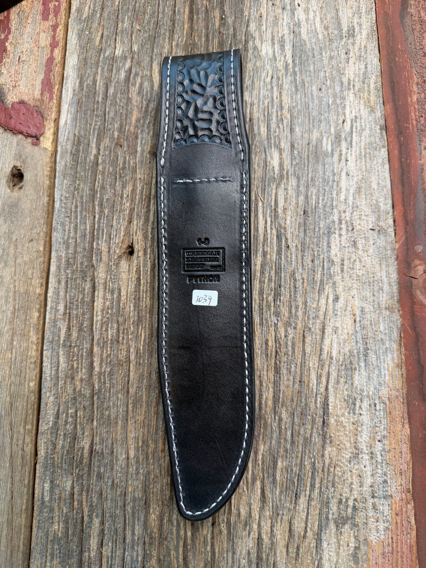 New Randall Model 1-8 Sheath in Exotic Brown Python Snake skin on black leather from Treeman with a black Canteen snap. Hand tooled belt loop. Deviated white stitching. Killer sheath.