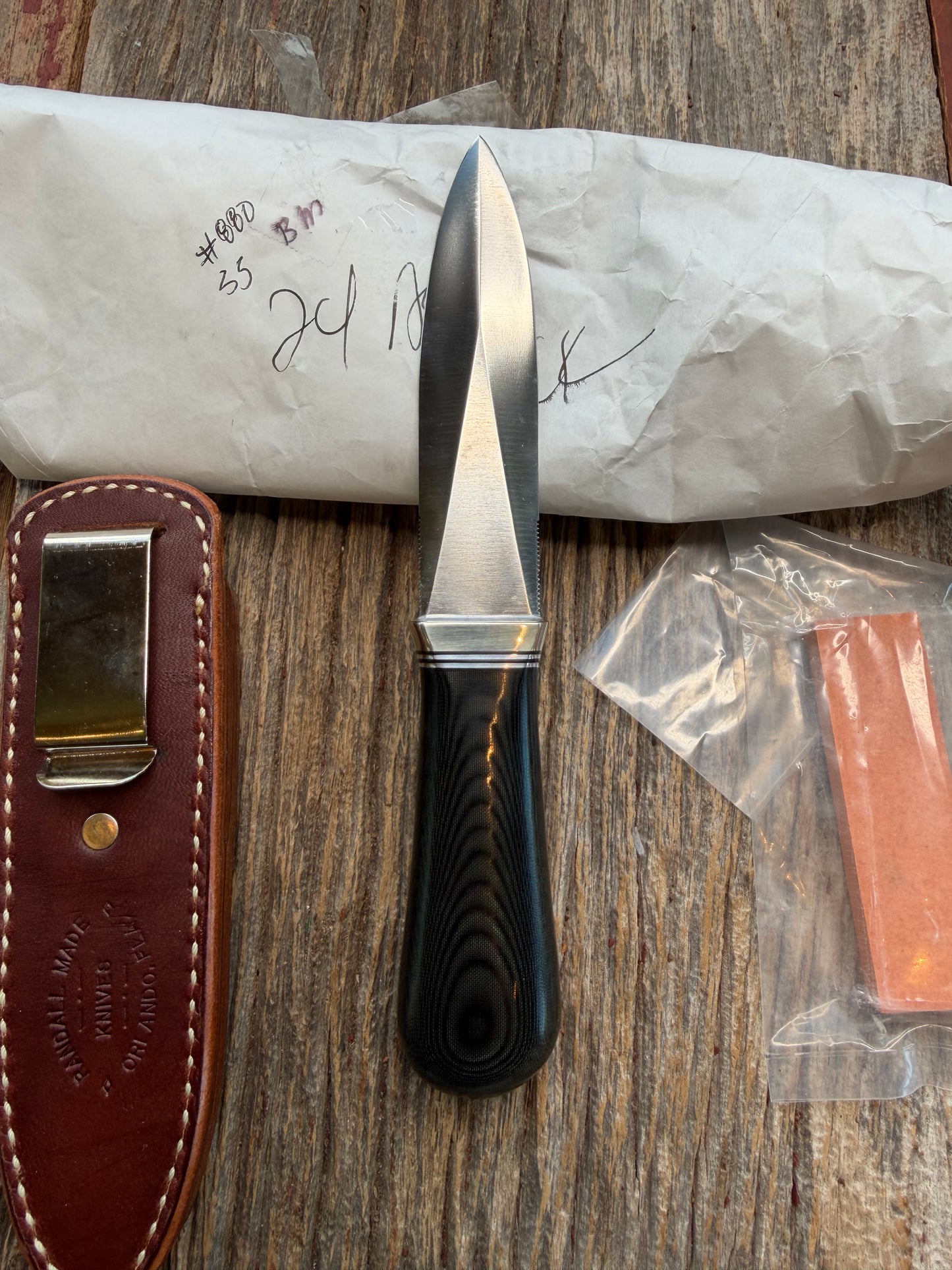 New in Paper Randall Model 24 Guardian in Black Micarta Nickel hilt, Stainless, black and aluminum spacers.