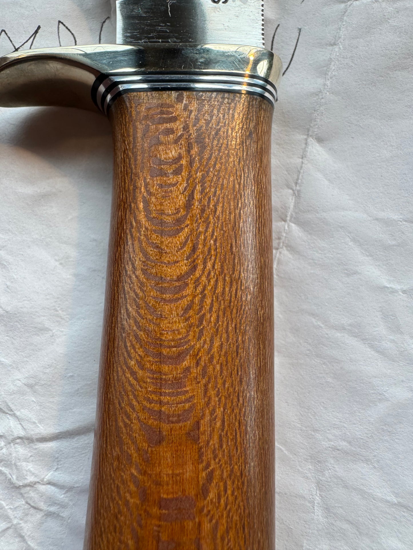 New in Paper Randall Model 19-5 Bushmaster with an Oak handle. SS blade, Nickel silver single hilt. Lanyard. Brown leather sheath.