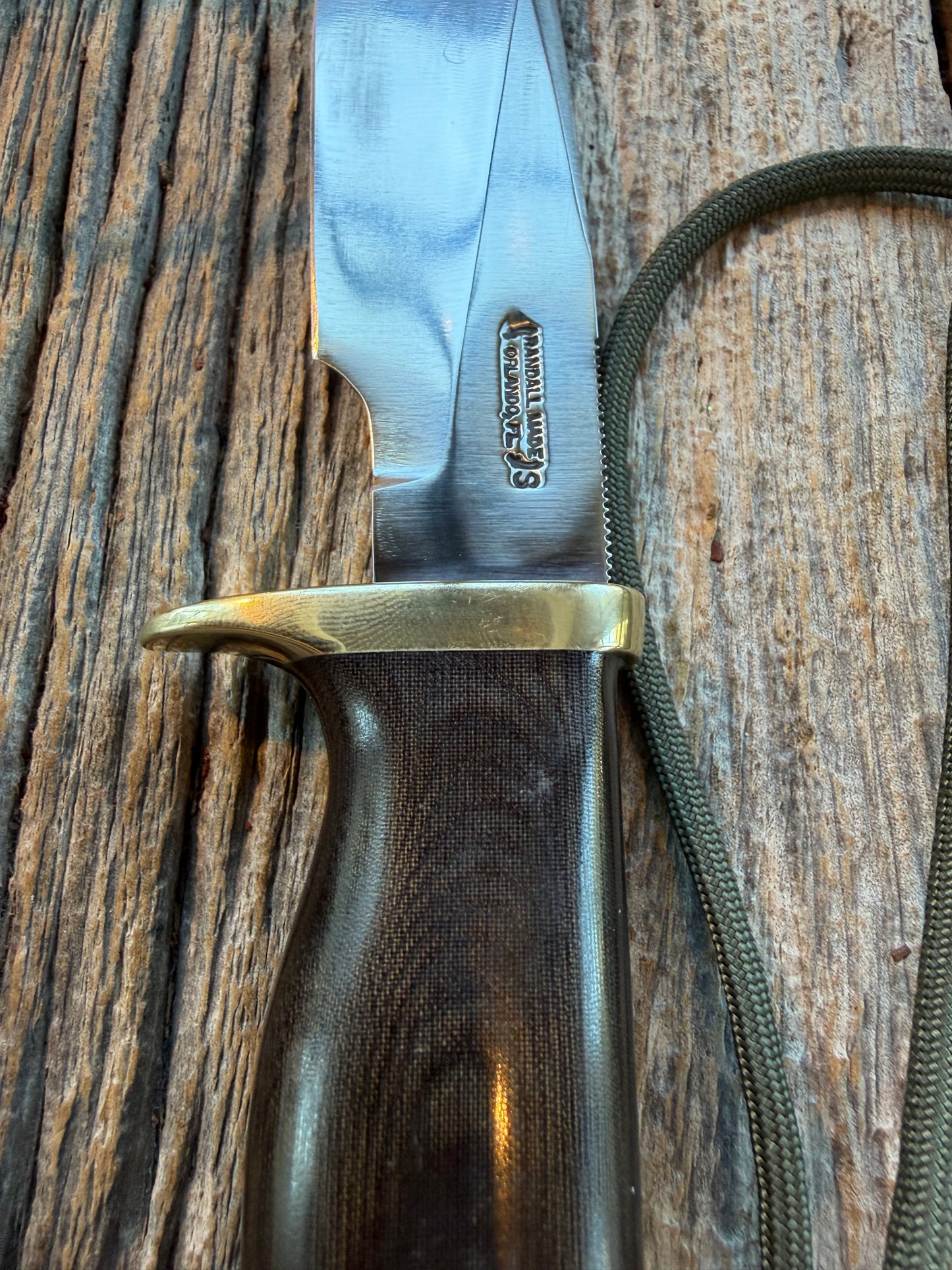 Nice Randall Model 28 Woodsman in Black Micarta. SS blade, brass single hilt. Lanyard. Brown leather sheath.