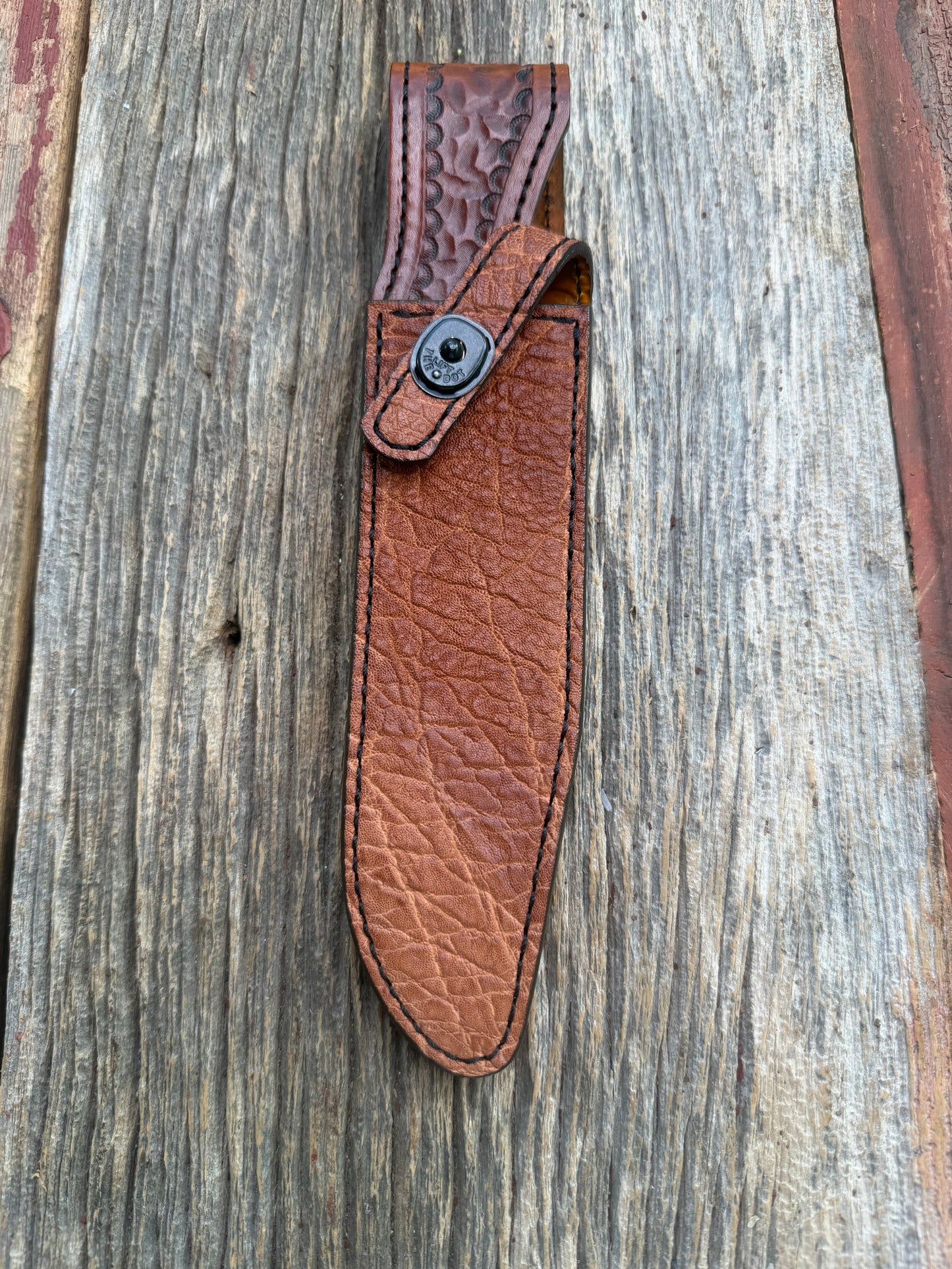 New Randall Model 1-7 Sheath in Exotic thick and textured Rust colored Elephant hide on brown leather from Treeman with a black Canteen snap. Hand tooled belt loop. Killer sheath.