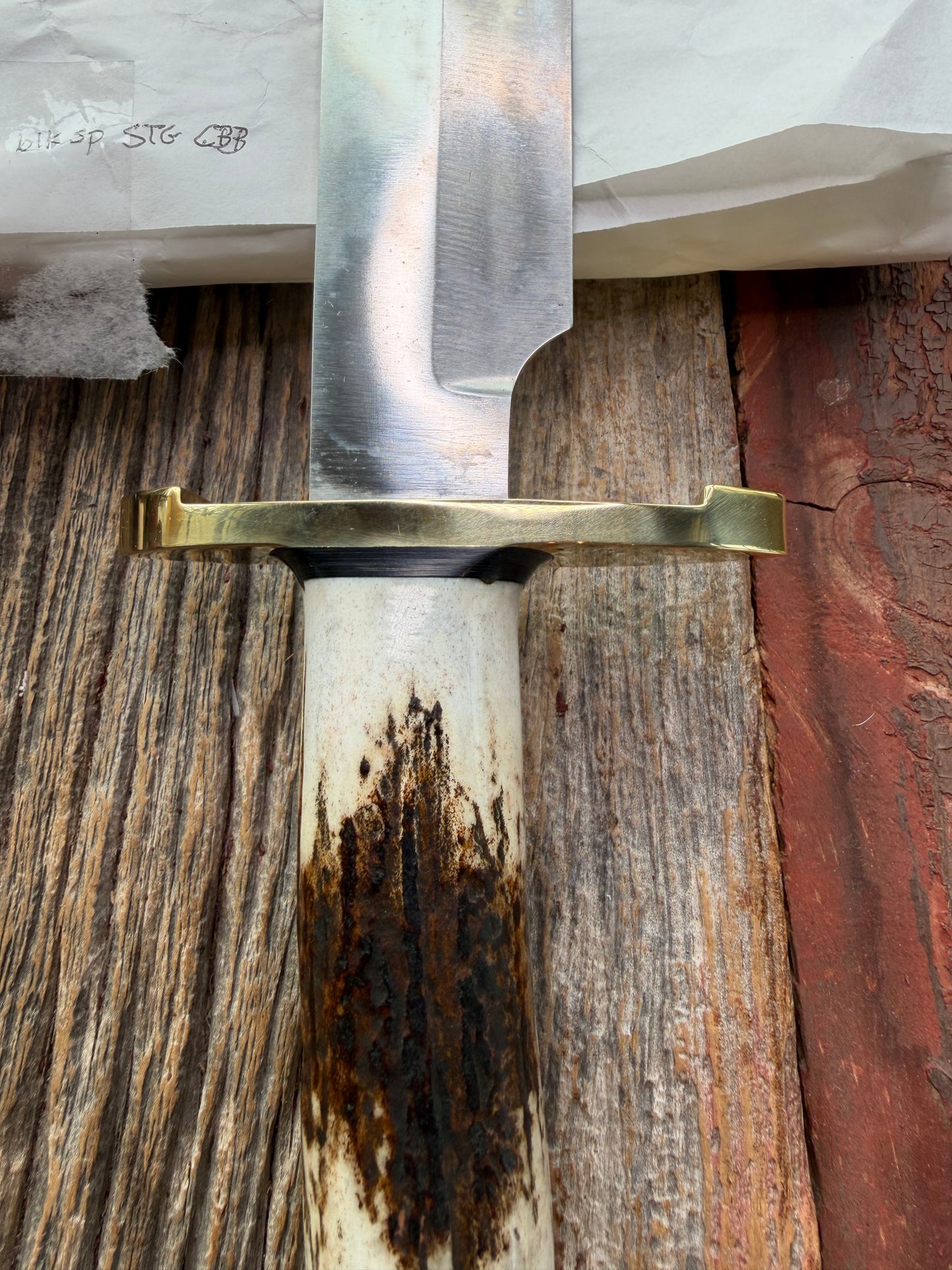 New in paper fresh from the Shop. Randall Knife Model 14-7.5 Big. Nice piece of Stag, Gorgeous Brass Lugged hilt and brass crows beak butt cap. Single black spacer. Stainless steel.